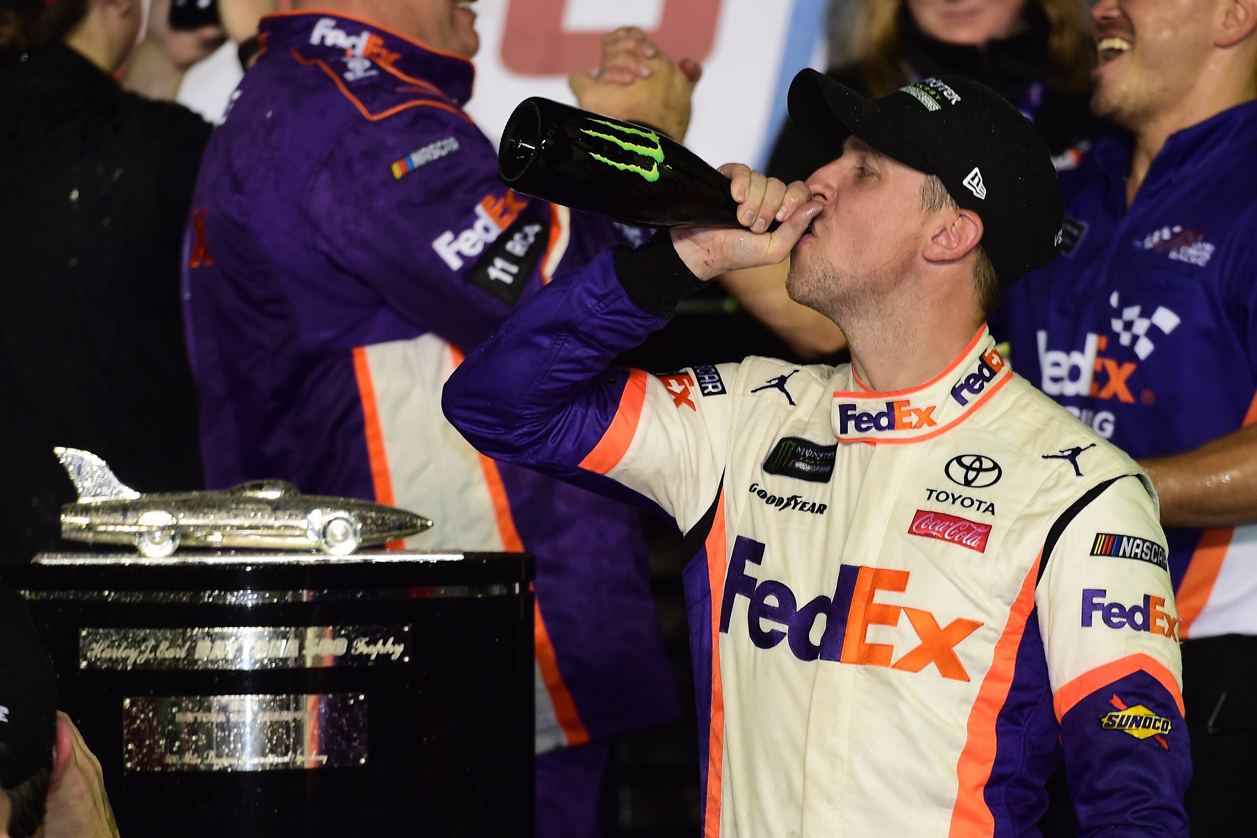 DAYTONA BEACH, FL - FEBRUARY 17:  Denny Hamlin, driver of the #11 FedEx Express Toyota, celebrates in victory lane after winning the Monster Energy NASCAR Cup Series 61st Annual Daytona 500 at Daytona International Speedway on February 17, 2019 in Daytona