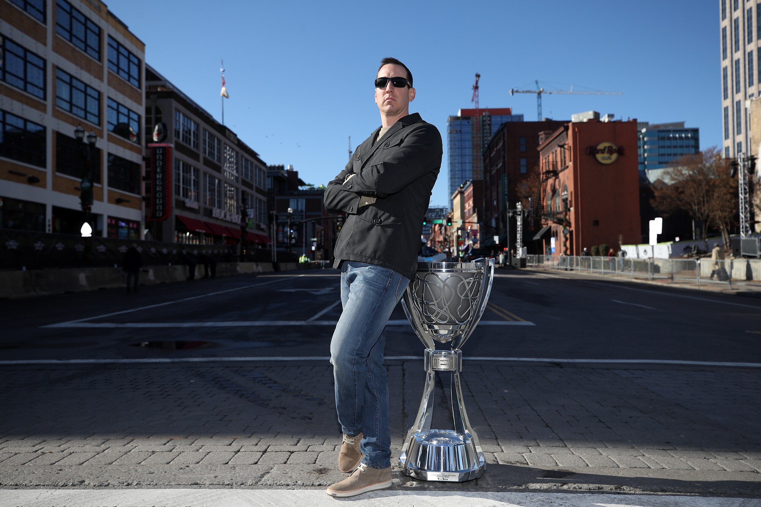 NASHVILLE, TENNESSEE - DECEMBER 04: Monster Energy NASCAR Cup Series Champion Kyle Busch poses for a photo on Broadway with the Championship Trophy on December 04, 2019 in Nashville, Tennessee. (Photo by Chris Graythen/Getty Images)