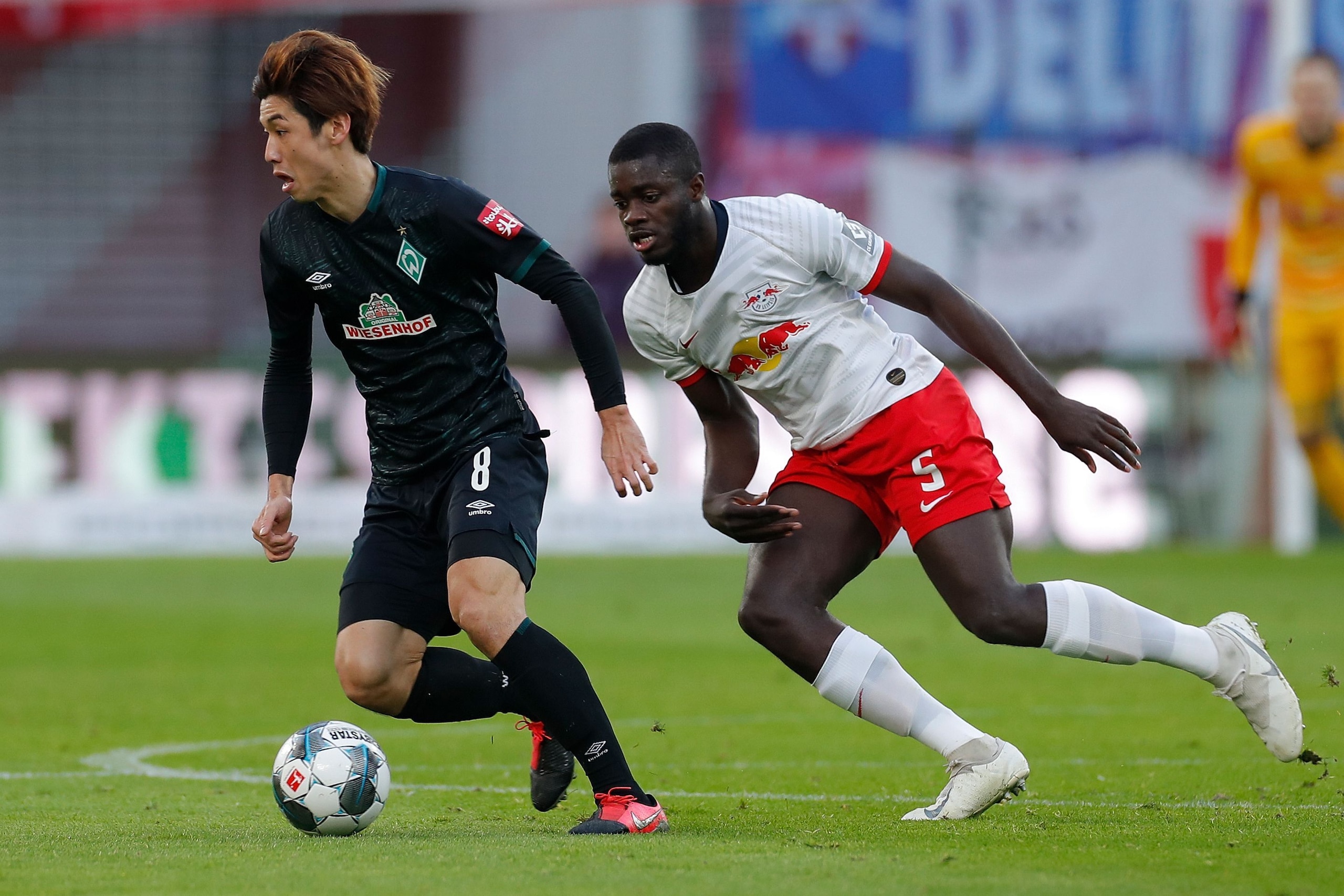 Bremen's Japanese forward Yuya Osako (L) and Leipzig's French defender Dayot Upamecano vie for the ball during the German first division Bundesliga football match RB Leipzig vs SV Werder Bremen, in Leipzig, eastern Germany on February 15, 2020. (Photo by 