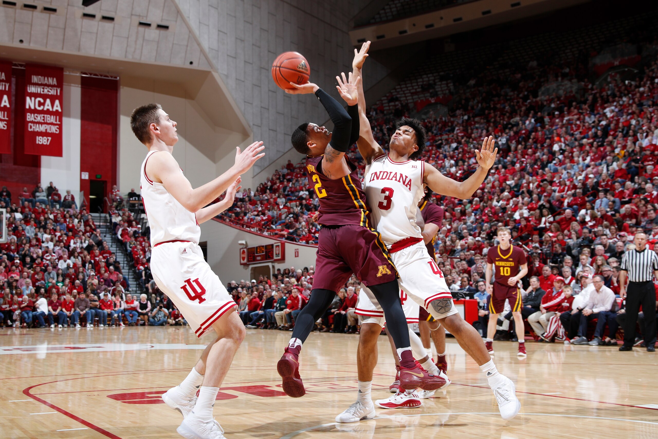 BLOOMINGTON, IN - FEBRUARY 09: Justin Smith #3 and Zach McRoberts #15 of the Indiana Hoosiers defend against Nate Mason #2 of the Minnesota Golden Gophers during a game at Assembly Hall on February 9, 2018 in Bloomington, Indiana. Indiana won 80-56. (Phot BLOOMINGTON, IN - FEBRUARY 09: Justin Smith #3 and Zach McRoberts #15 of the Indiana Hoosiers defend against Nate Mason #2 of the Minnesota Golden Gophers during a game at Assembly Hall on February 9, 2018 in Bloomington, Indiana. Indiana won 80-56. (Phot