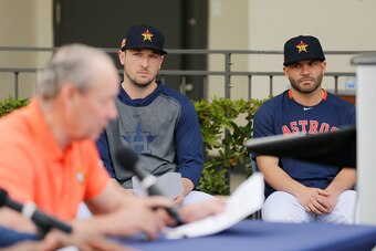 WEST PALM BEACH, FLORIDA - FEBRUARY 13:  Alex Bregman #2 and Jose Altuve #27 of the Houston Astros look on as owner Jim Crane reads a prepared statement during a press conference at FITTEAM Ballpark of The Palm Beaches on February 13, 2020 in West Palm Be