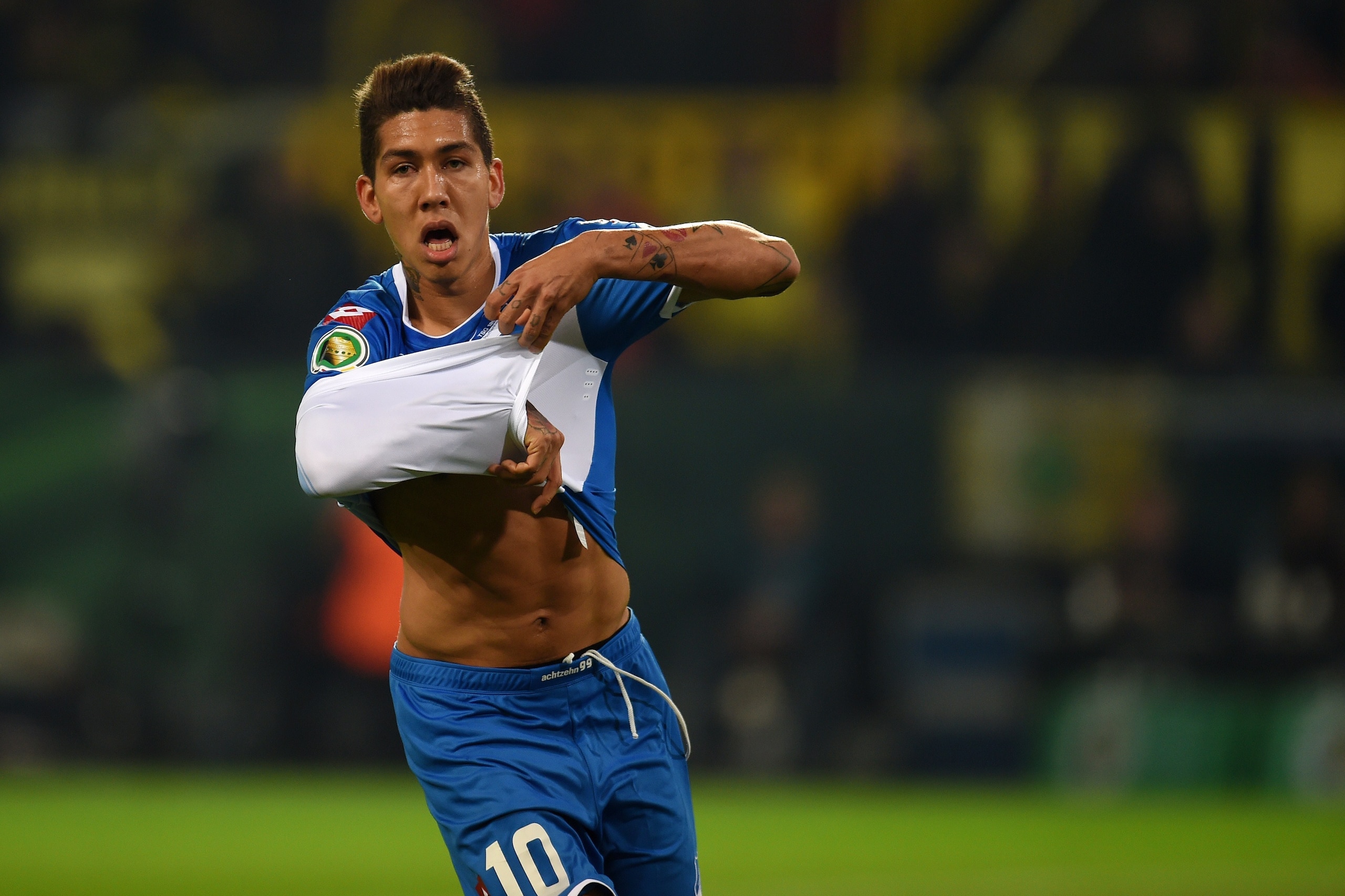 Hoffenheim's Brazilian midfielder Roberto Firmino celebrates during the German trophy football match Borussia Dortmund vs TSG Hoffenheim in the Signal Iduna Park stadium in Dortmund, western Germany on April 7, 2015. AFP PHOTO / PATRIK STOLLARZ

DFL RULES