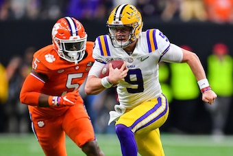 NEW ORLEANS, LOUISIANA - JANUARY 13: With the help of down field blockers, Joe Burrow #9 of the LSU Tigers, breaks free for a 29-yard run  during the second quarter of the College Football Playoff National Championship game at the Mercedes Benz Superdome 