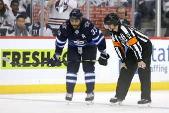 WINNIPEG, MANITOBA - APRIL 10: Dustin Byfuglien #33 of the Winnipeg Jets chats to a referee during a break in action with the St. Louis Blues in Game One of the Western Conference First Round during the 2019 NHL Stanley Cup Playoffs at Bell MTS Place on A