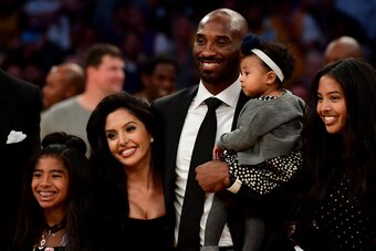 LOS ANGELES, CA - DECEMBER 18:  Kobe Bryant poses with his family at halftime after both his #8 and #24 Los Angeles Lakers jerseys are retired at Staples Center on December 18, 2017 in Los Angeles, California. NOTE TO USER: User expressly acknowledges and