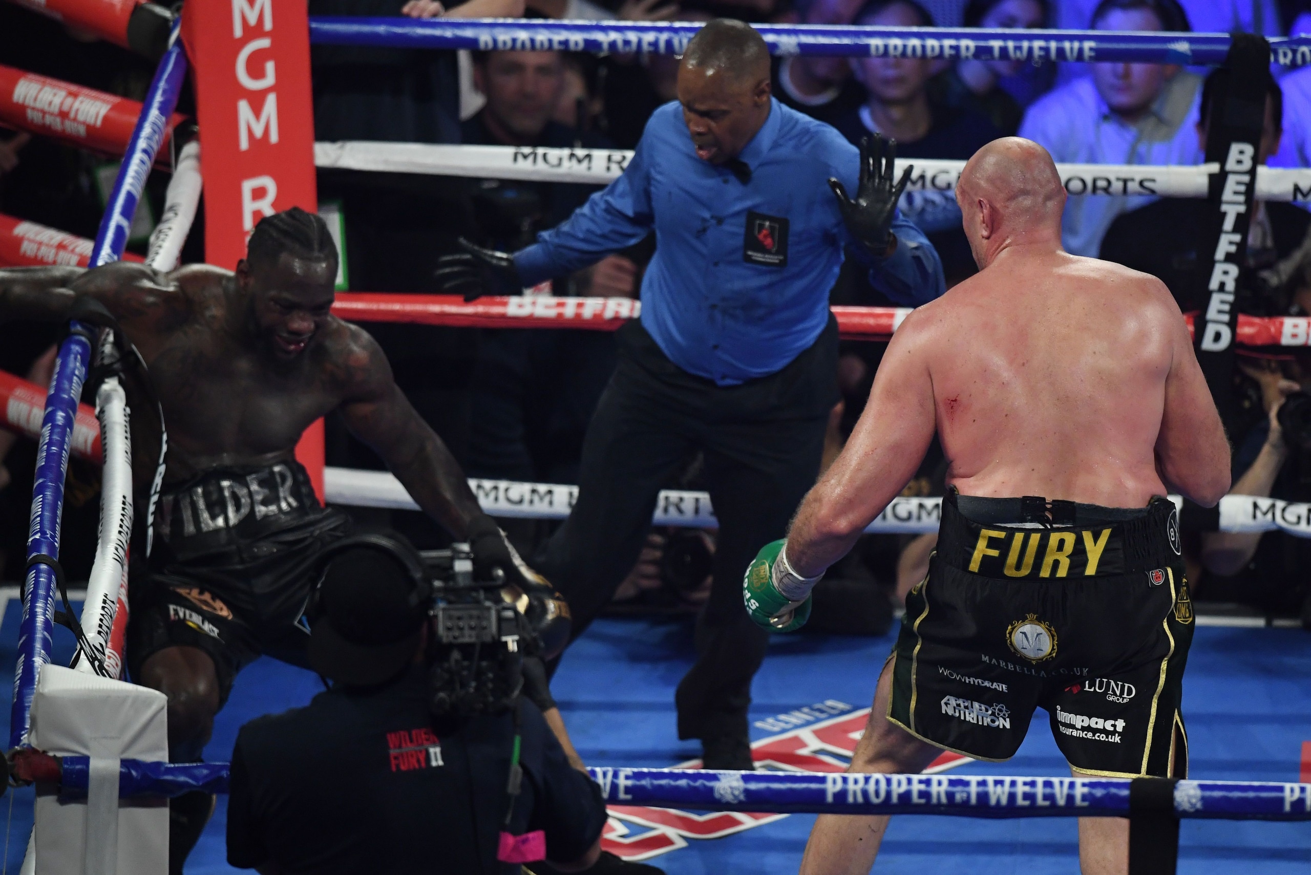 British boxer Tyson Fury (R) knocks US boxer Deontay Wilder down before defeating him in the seventh round during their World Boxing Council (WBC) Heavyweight Championship Title boxing match at the MGM Grand Garden Arena in Las Vegas on February 22, 2020.