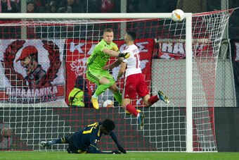 PIRAEUS, GREECE - FEBRUARY 20: Bernd Leno of Arsenal FC and Giorgos Masouras of Olympiacos FC during the UEFA Europa League round of 32 first leg match between Olympiacos FC and Arsenal FC at Karaiskakis Stadium on February 20, 2020 in Piraeus, Greece. (P