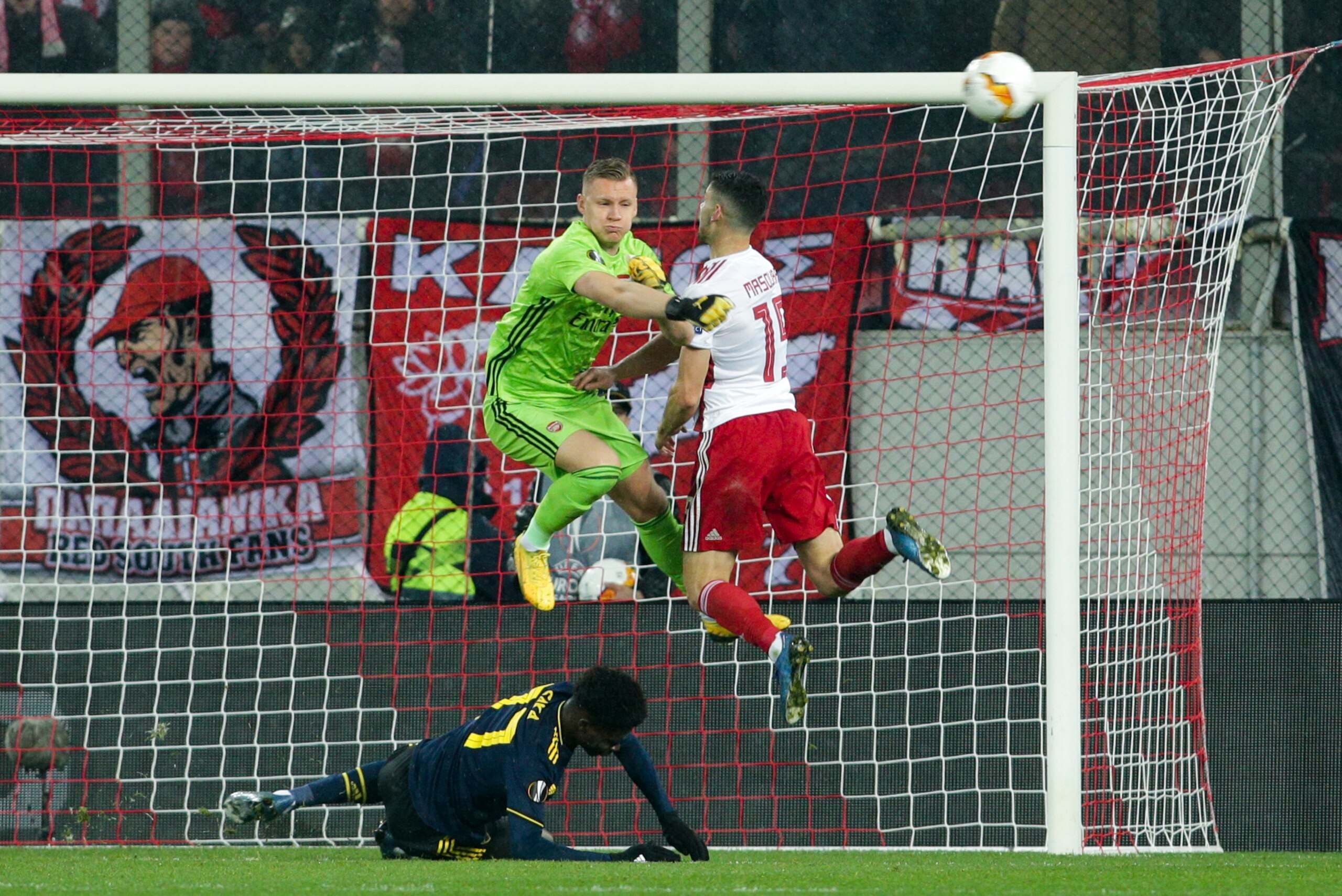 PIRAEUS, GREECE - FEBRUARY 20: Bernd Leno of Arsenal FC and Giorgos Masouras of Olympiacos FC during the UEFA Europa League round of 32 first leg match between Olympiacos FC and Arsenal FC at Karaiskakis Stadium on February 20, 2020 in Piraeus, Greece. (P