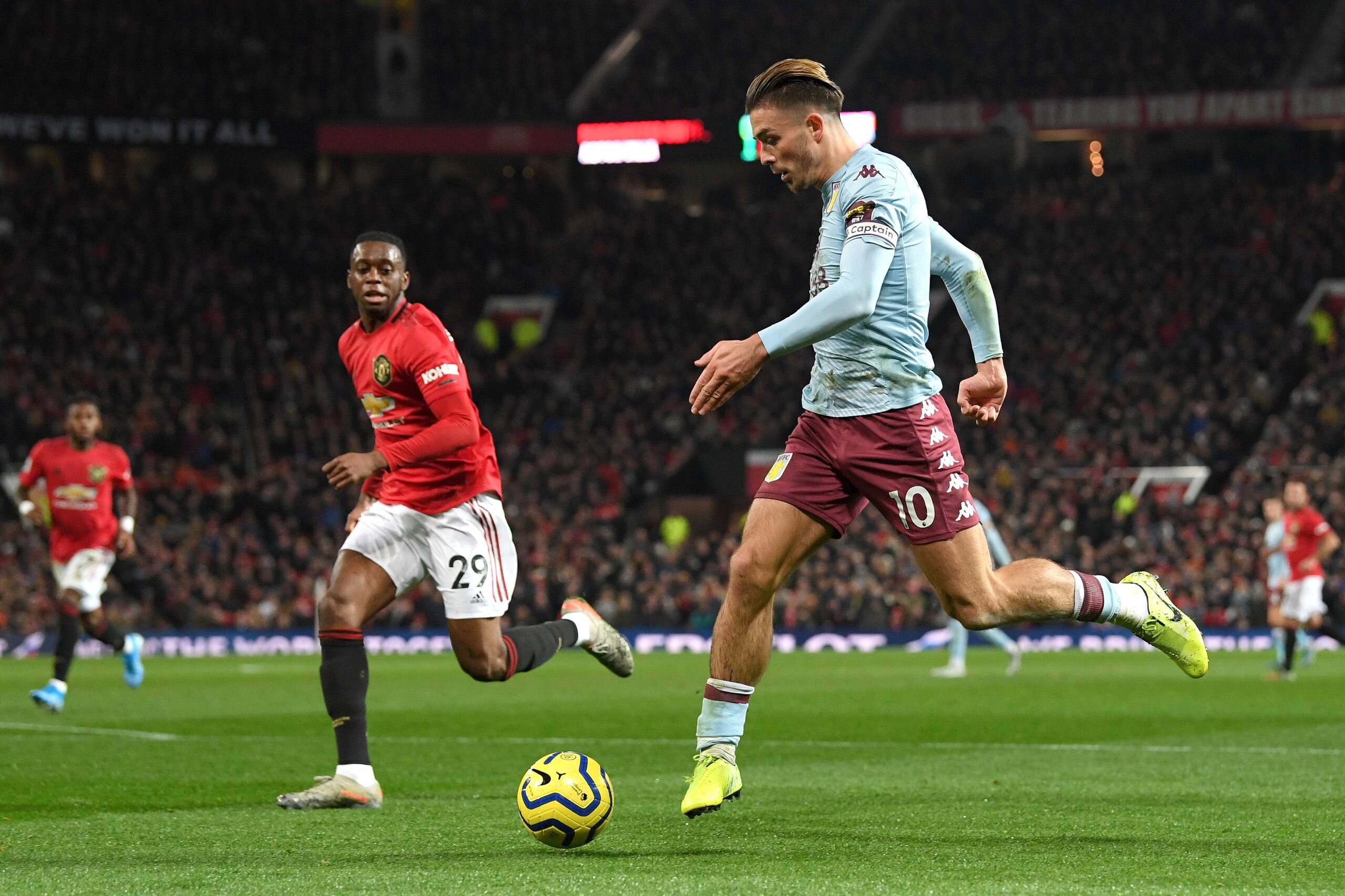 MANCHESTER, ENGLAND - DECEMBER 01: Jack Grealish of Aston Villa controls the ball as Aaron Wan-Bissaka of Manchester United looks on during the Premier League match between Manchester United and Aston Villa at Old Trafford on December 01, 2019 in Manchest