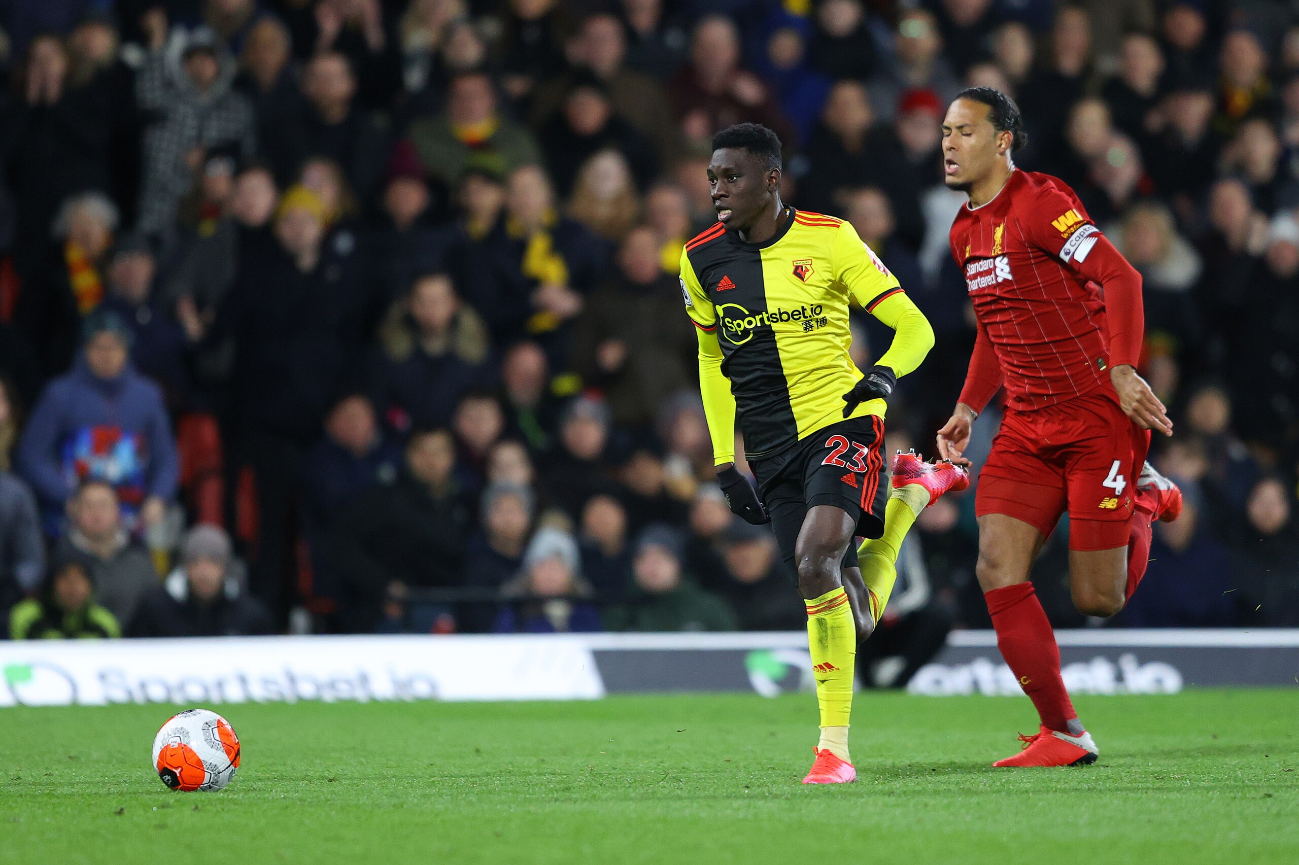 WATFORD, ENGLAND - FEBRUARY 29: Ismaila Sarr of Watford runs with the ball past Virgil van Dijk of Liverpool to score his team's second goal during the Premier League match between Watford FC and Liverpool FC at Vicarage Road on February 29, 2020 in Watfo