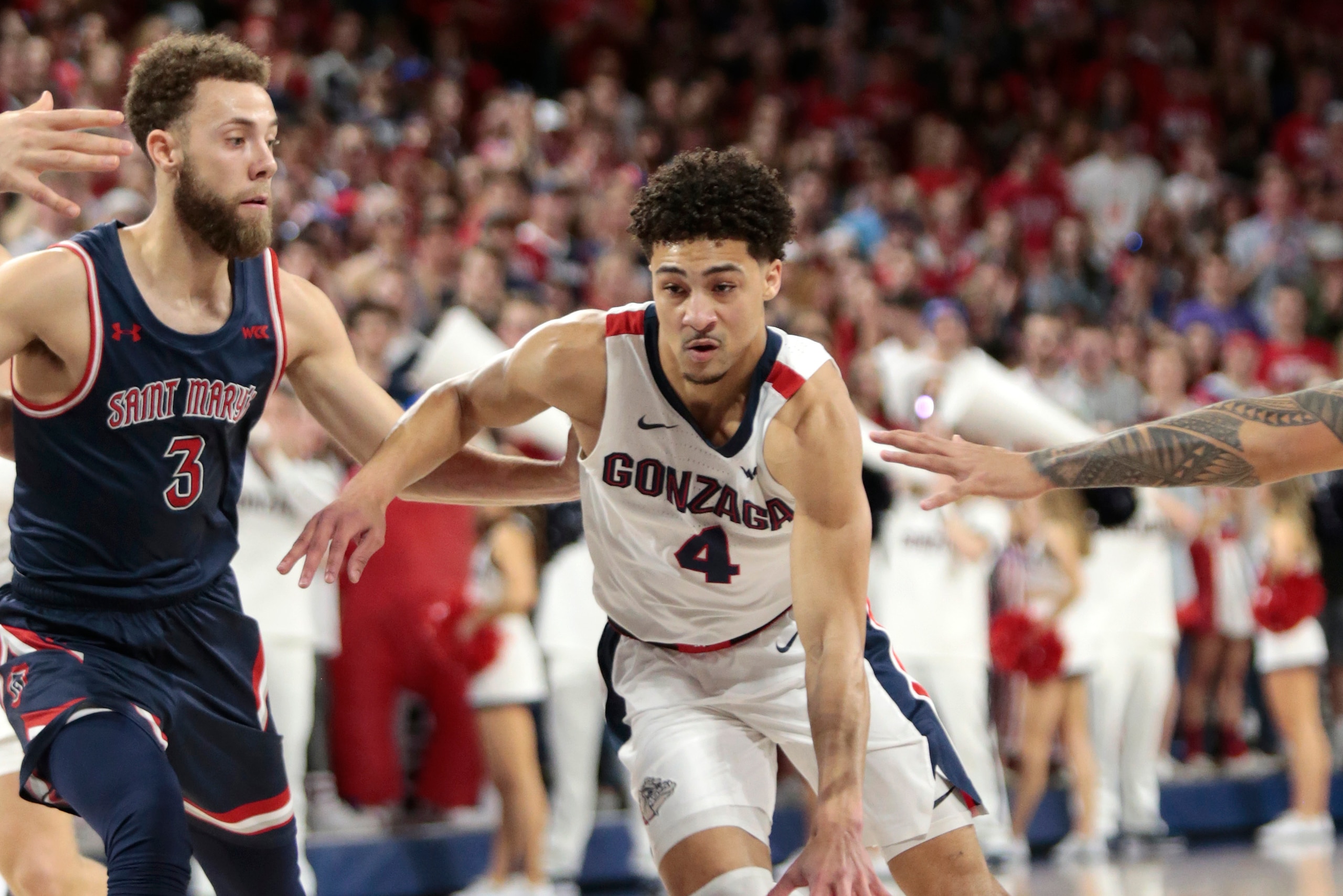 SPOKANE, WASHINGTON - FEBRUARY 29: Ryan Woolridge #4 of the Gonzaga Bulldogs drives against Jordan Ford #3 of the Saint Mary's Gaels in the first half at McCarthey Athletic Center on February 29, 2020 in Spokane, Washington. (Photo by William Mancebo/Gett