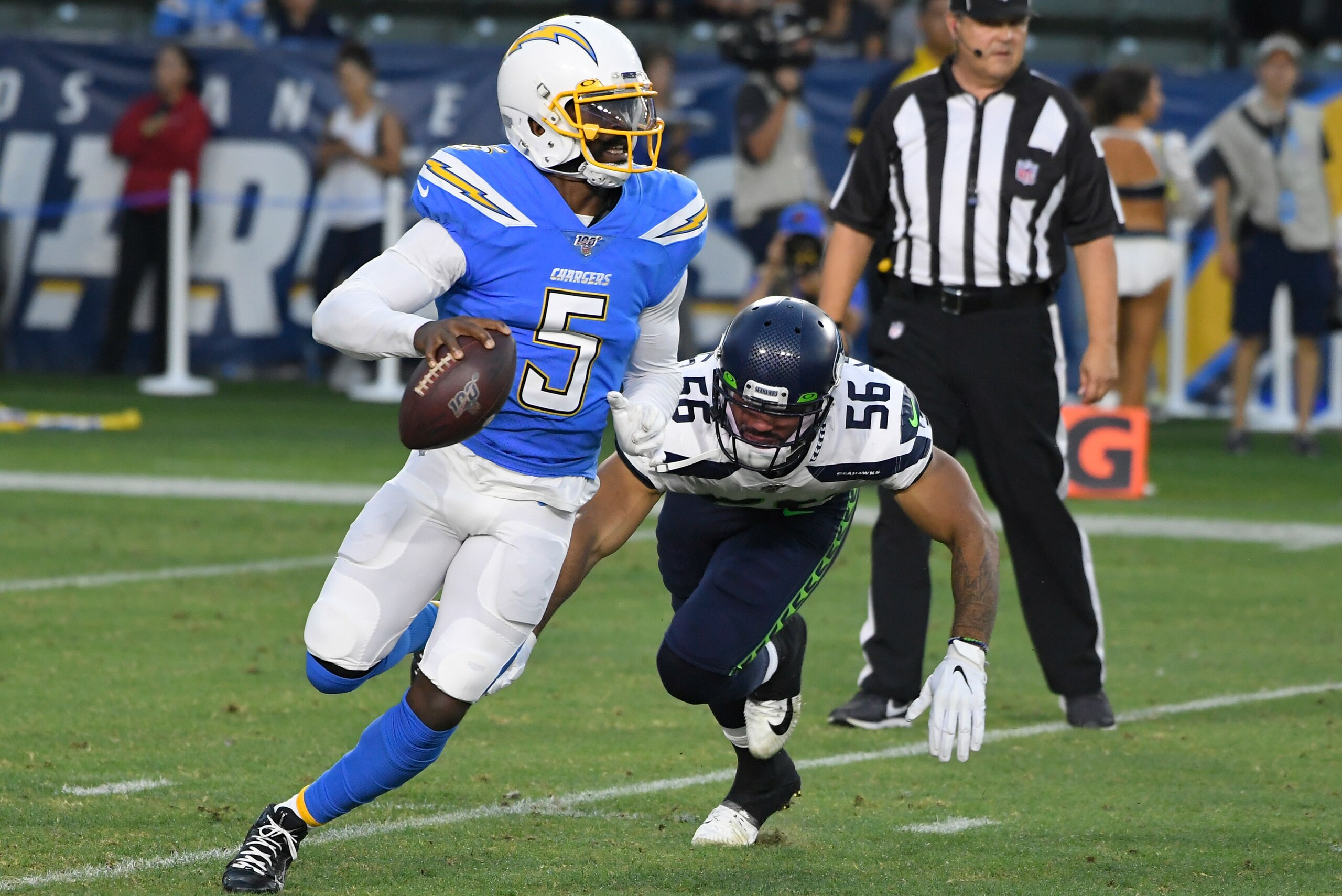 CARSON, CA - AUGUST 24: Tyrod Taylor #5 of the Los Angeles Chargers avoids Mychal Kendricks #56 of the Seattle Seahawks during a preseason NFL football game at Dignity Health Sports Park on August 24, 2019 in Carson, California. The Seattle Seahawks won 2