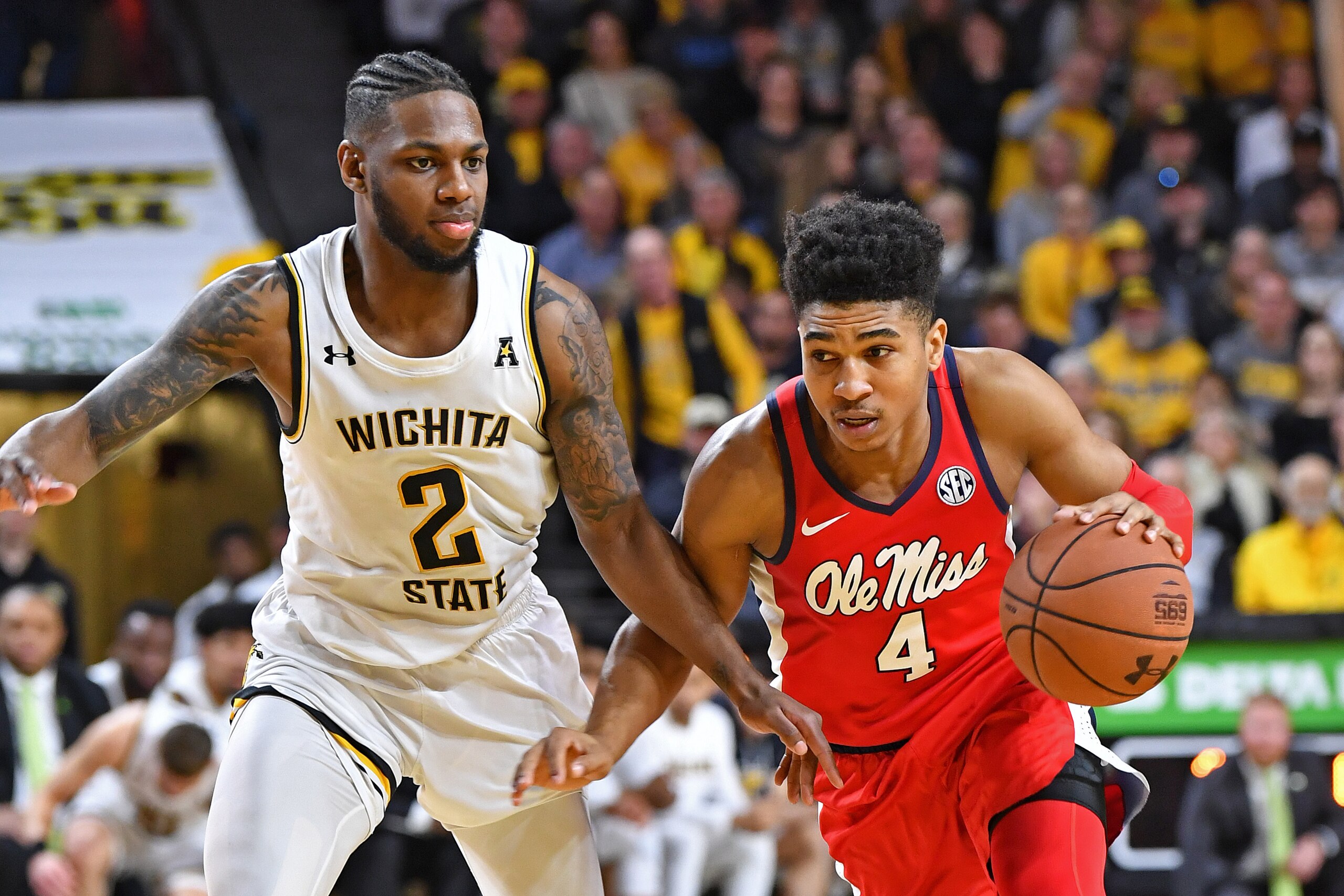 WICHITA, KS - JANUARY 04:  Breein Tyree #4 of the Mississippi Rebels drives up court against Jamarius Burton #2 of the Wichita State Shockers during the second half on January 4, 2020 at Charles Koch Arena in Wichita, Kansas.  (Photo by Peter G. Aiken/Get