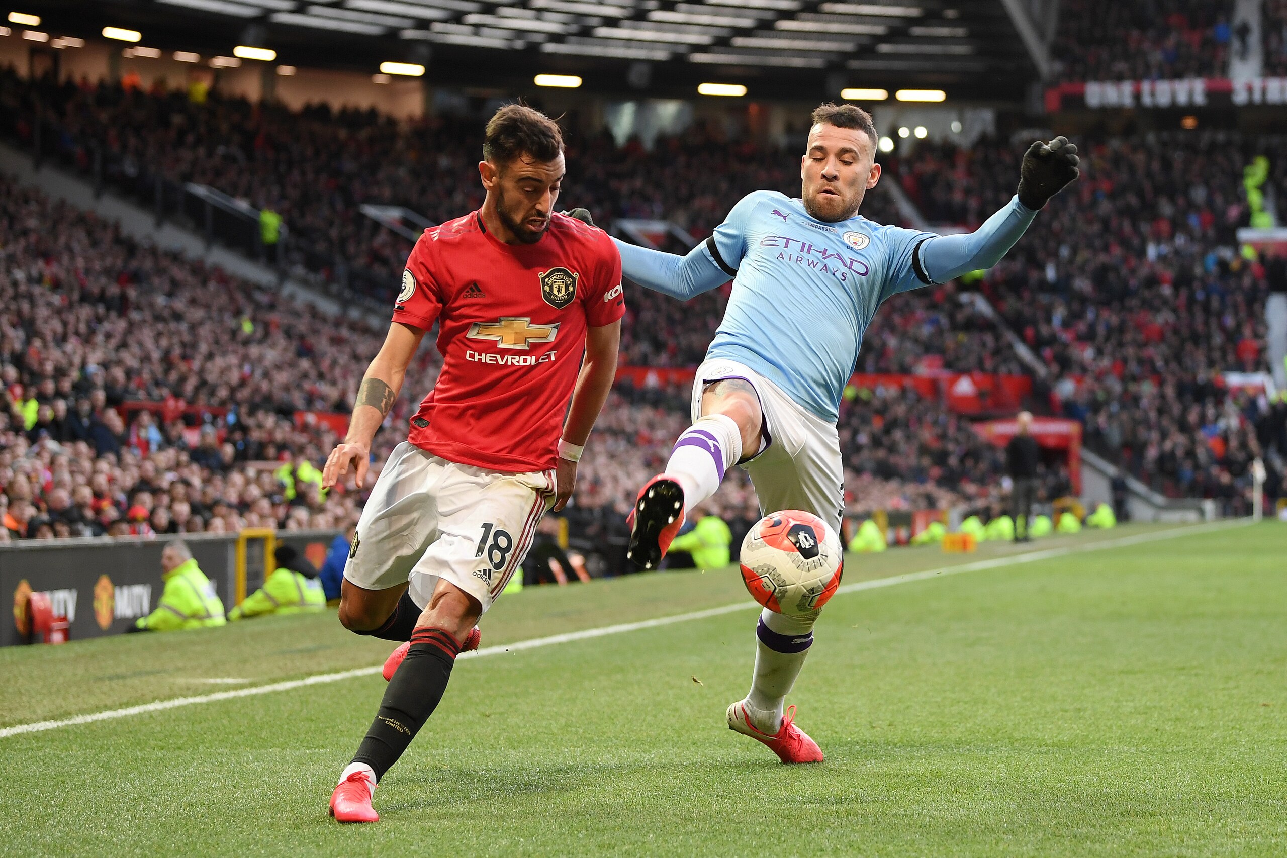 MANCHESTER, ENGLAND - MARCH 08: Bruno Fernandes of Manchester United battles for possession with Nicolas Otamendi of Manchester City  during the Premier League match between Manchester United and Manchester City at Old Trafford on March 08, 2020 in Manche
