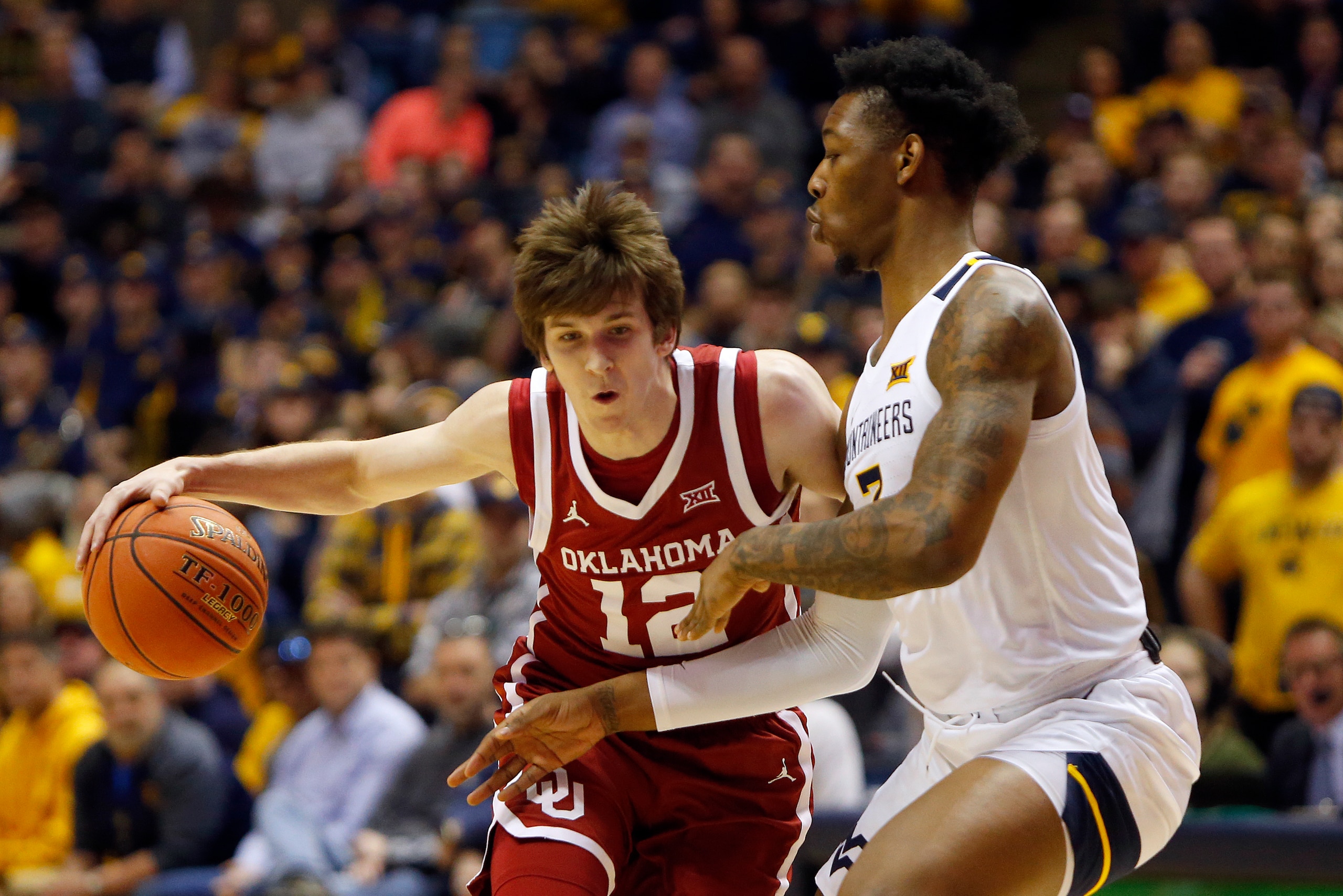 MORGANTOWN, WV - FEBRUARY 29:  Austin Reaves #12 of the Oklahoma Sooners handles the ball against Gabe Osabuohien #3 of the West Virginia Mountaineers at the WVU Coliseum on February 29, 2020 in Morgantown, West Virginia.  (Photo by Justin K. Aller/Getty 