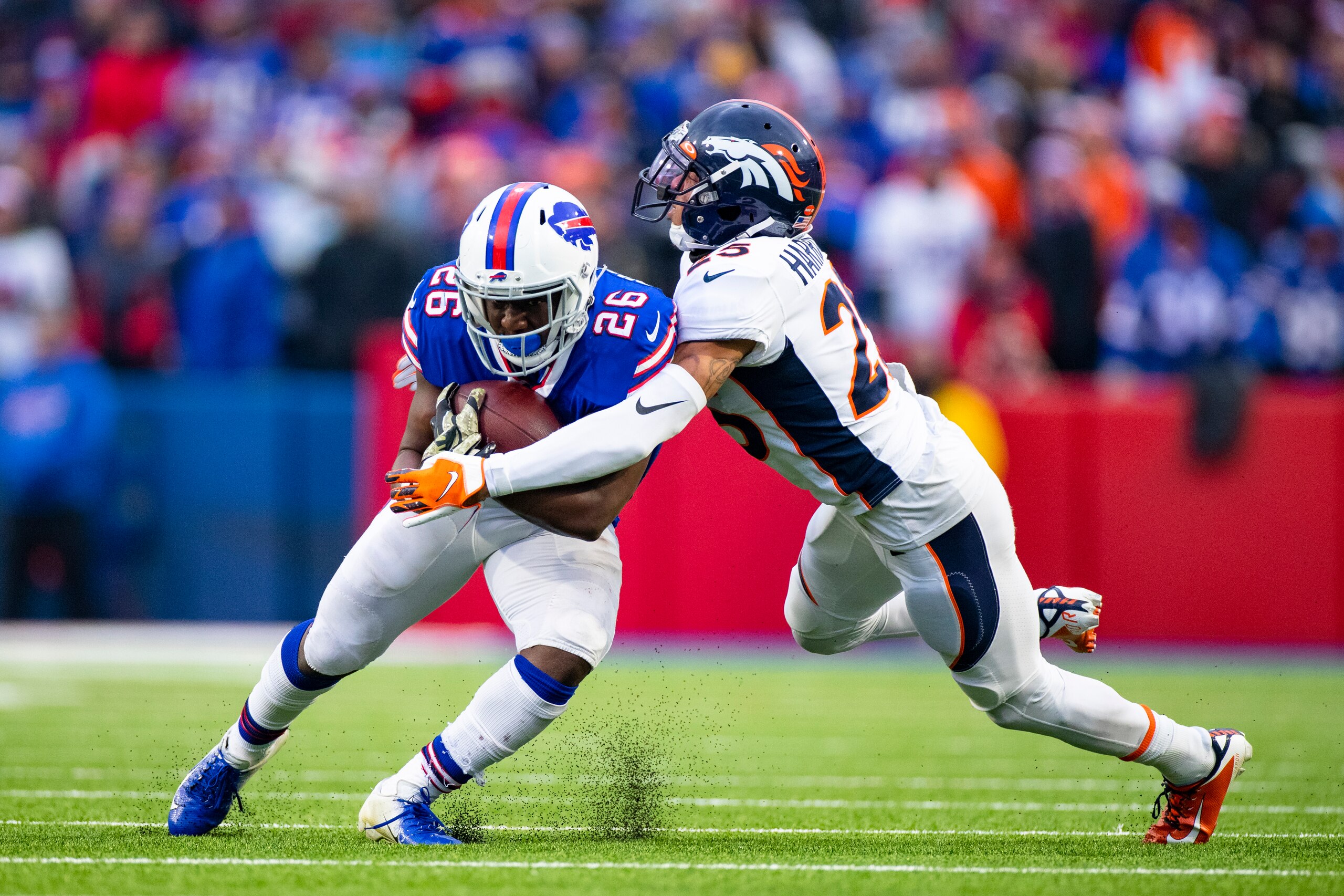 ORCHARD PARK, NY - NOVEMBER 24: Chris Harris #25 of the Denver Broncos tackles Devin Singletary #26 of the Buffalo Bills during the fourth quarter at New Era Field on November 24, 2019 in Orchard Park, New York. Buffalo defeats Denver 20-3. (Photo by Br ORCHARD PARK, NY - NOVEMBER 24: Chris Harris #25 of the Denver Broncos tackles Devin Singletary #26 of the Buffalo Bills during the fourth quarter at New Era Field on November 24, 2019 in Orchard Park, New York. Buffalo defeats Denver 20-3. (Photo by Br