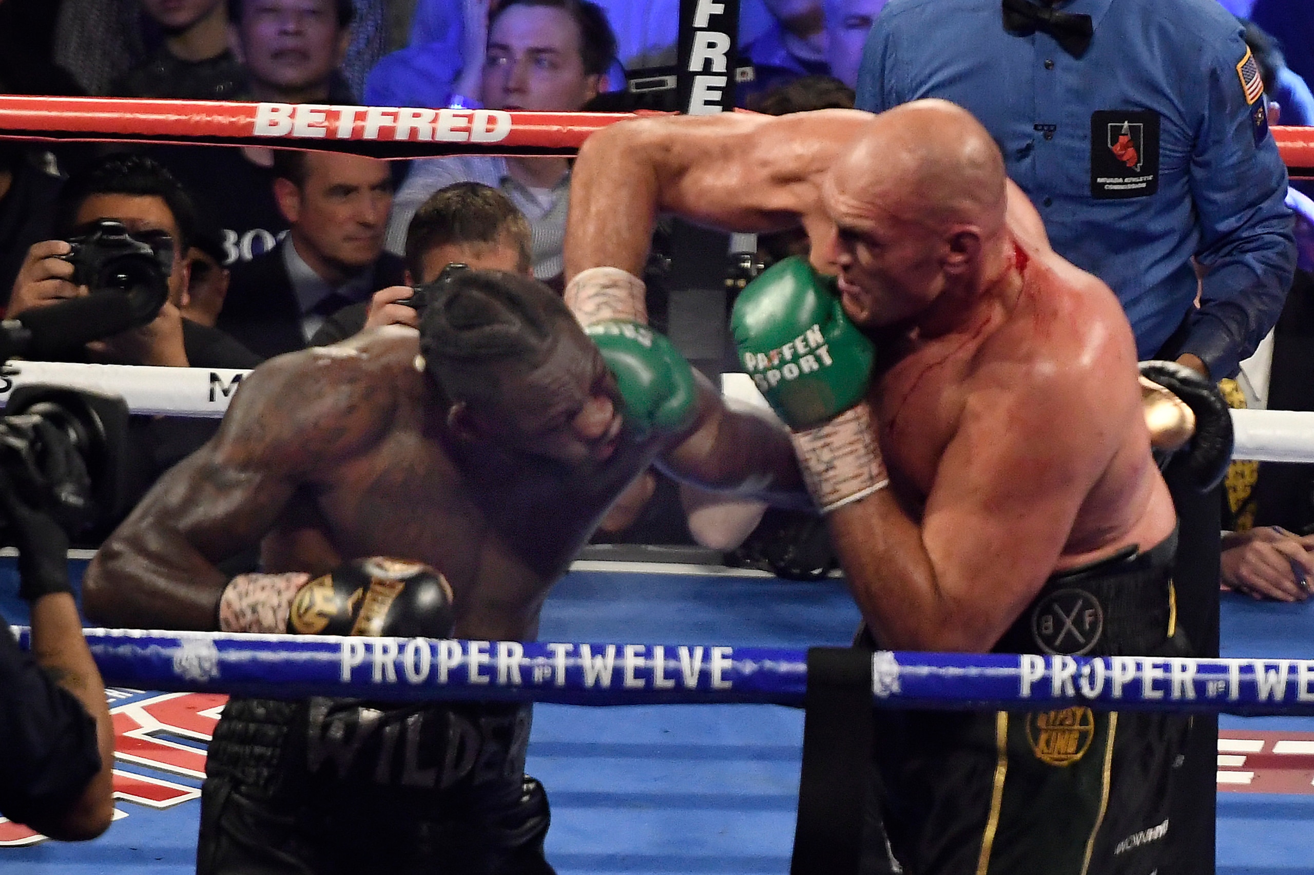 LAS VEGAS, NV - FEBRUARY 22: (in black//yellow trunks) Tyson Fury  goes 7 rounds with Deontay Wilder at the MGM Grand Hotel February 22, 2020 in Las Vegas, Nevada.   Tyson Fury took the win by TKO in the 7th round as the towel was thrown in by the Wilder 