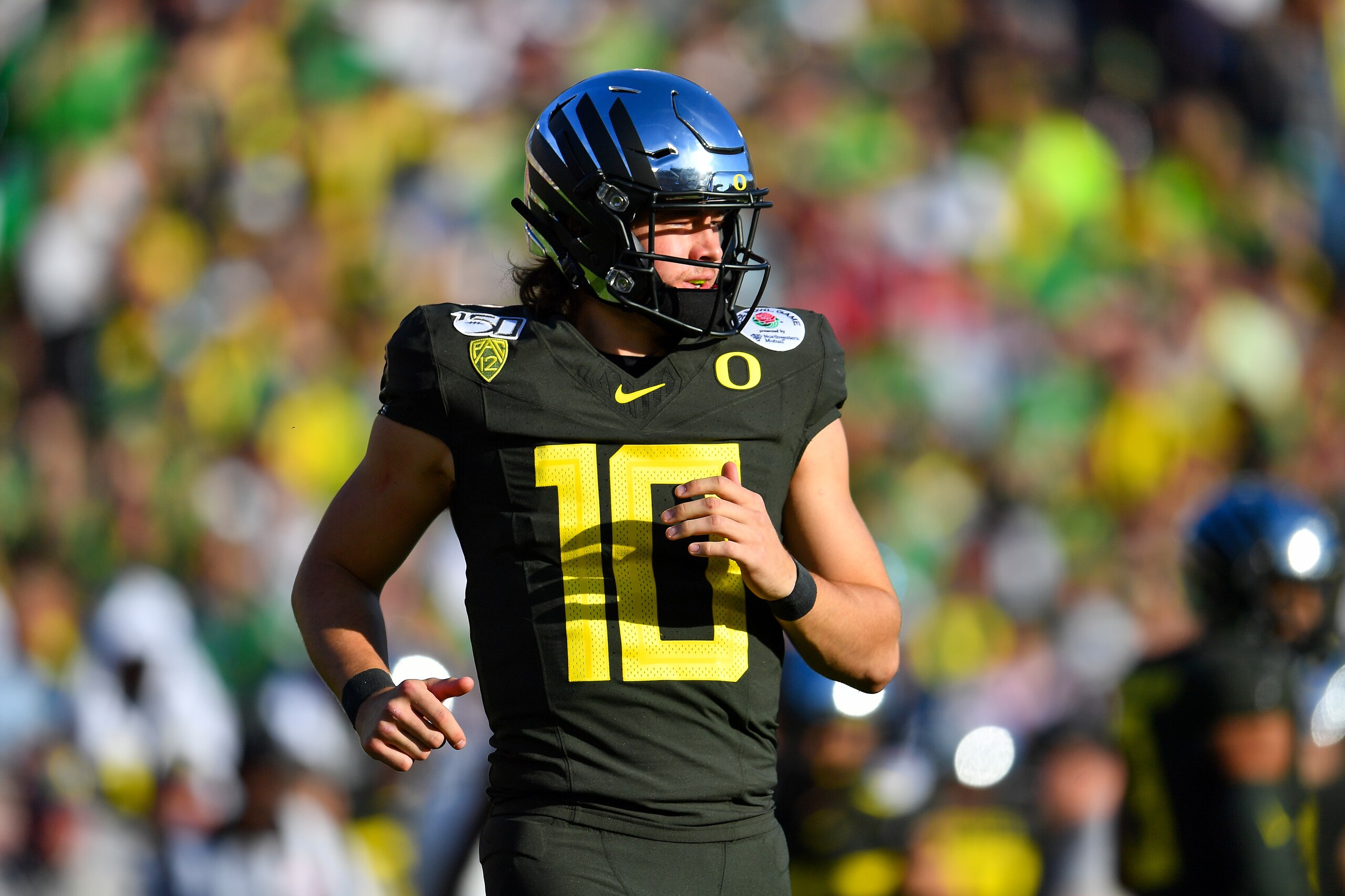 PASADENA, CALIFORNIA - JANUARY 01: Justin Herbert #10 of the Oregon Ducks runs to the huddle during the first quarter of the game against the Wisconsin Badgers at the Rose Bowl on January 01, 2020 in Pasadena, California. (Photo by Alika Jenner/Getty Imag