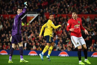 Arsenal's Gabonese striker Pierre-Emerick Aubameyang (C) looks to the assistant referee after scoring, decision of off-side overturned by VAR (Video Assistant referee) during the English Premier League football match between Manchester United and Arsenal 