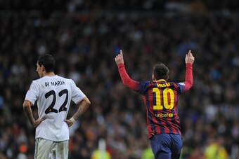 MADRID, SPAIN - MARCH 23: Lionel Messi of Barcelona celebrates beside Angel Di Maria of Real Madrid after scoring his team's third goal during the La Liga match between Real Madrid CF and FC Barcelona at the Bernabeu on March 23, 2014 in Madrid, Spain.  (