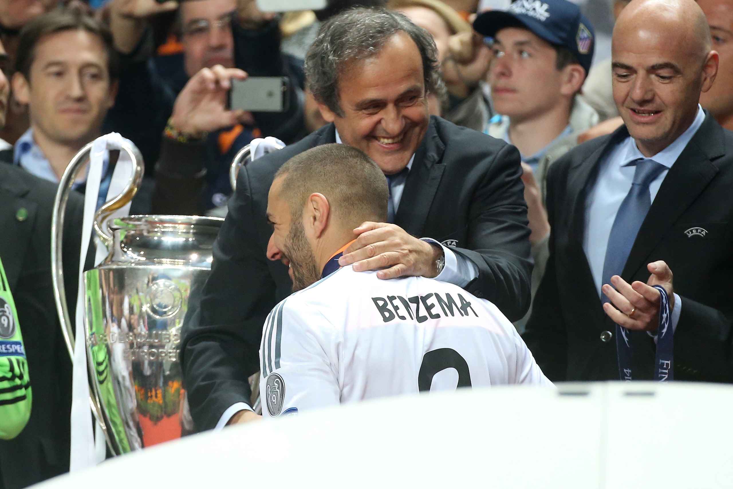LISBON, PORTUGAL - MAY 24: President of UEFA Michel Platini congratulates countryman Karim Benzema of Real Madrid during the trophy ceremony after the UEFA Champions League final between Real Madrid and Atletico de Madrid at Estadio da Luz stadium on May 