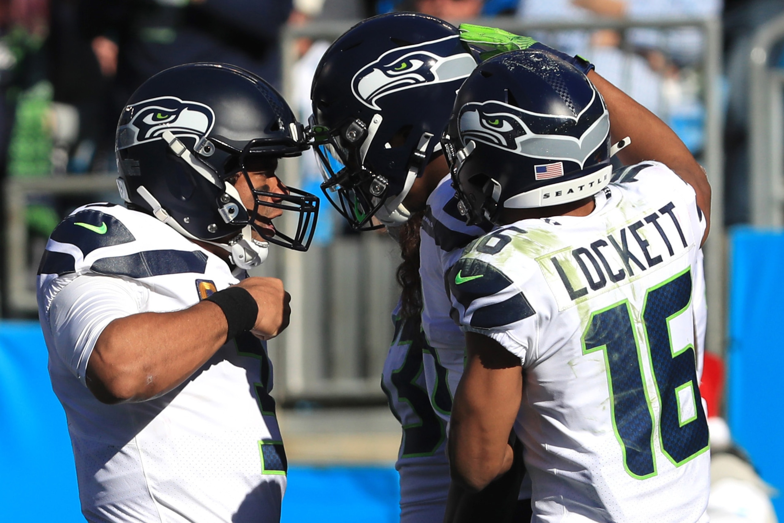 CHARLOTTE, NORTH CAROLINA - DECEMBER 15: Seattle Seahawks quarterback Russell Wilson #3, wide receiver Tyler Lockett #16 and wide receiver D.K. Metcalf #14 celebrate the touchdown in the first quarter against Carolina Panthers at Bank of America Stadium o CHARLOTTE, NORTH CAROLINA - DECEMBER 15: Seattle Seahawks quarterback Russell Wilson #3, wide receiver Tyler Lockett #16 and wide receiver D.K. Metcalf #14 celebrate the touchdown in the first quarter against Carolina Panthers at Bank of America Stadium o