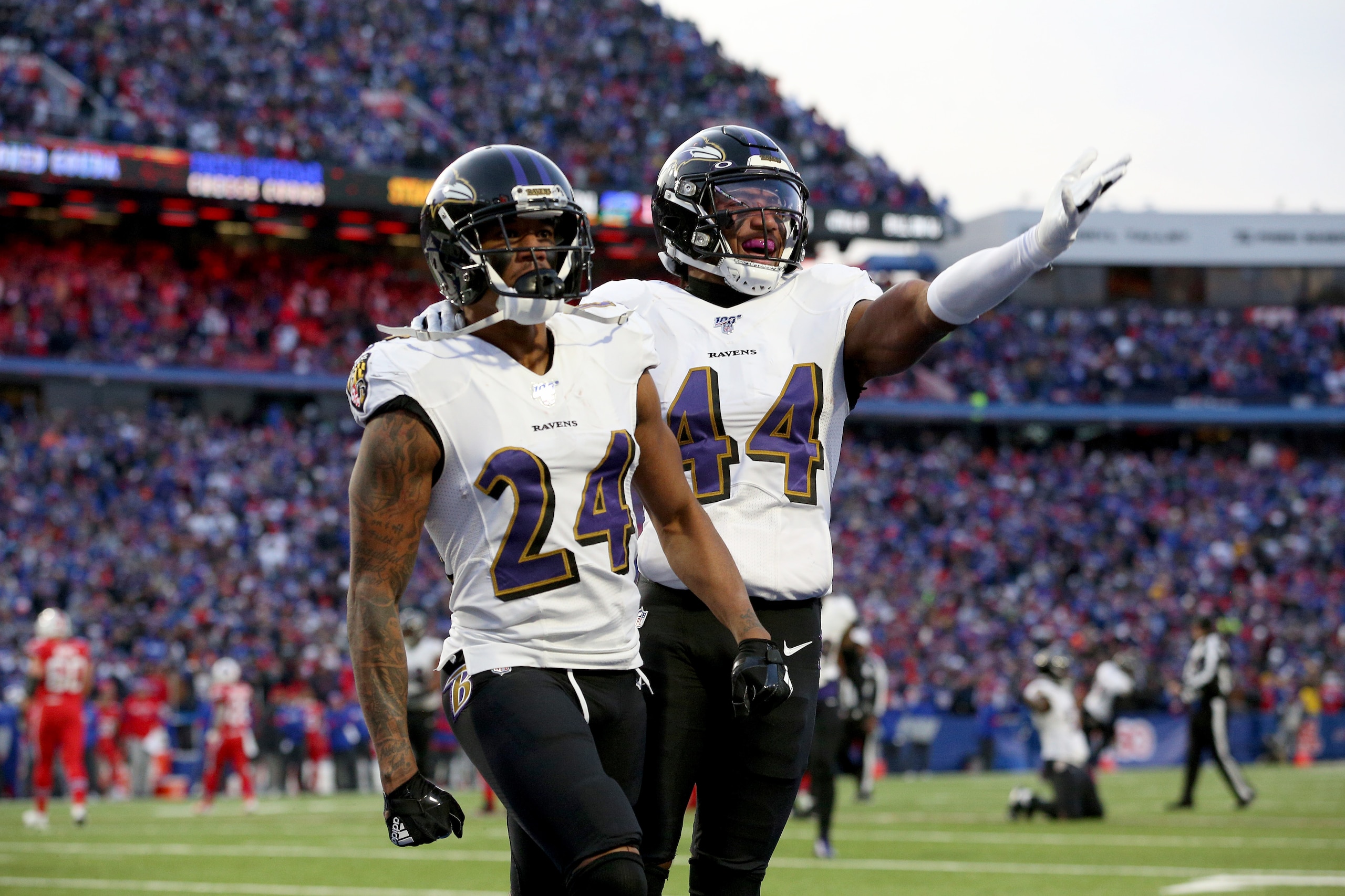 ORCHARD PARK, NEW YORK - DECEMBER 08: Marcus Peters #24 and teammate Marlon Humphrey #44 of the Baltimore Ravens react after breaking up a pass during the fourth quarter of an NFL game against the Buffalo Bills at New Era Field on December 08, 2019 in Orc