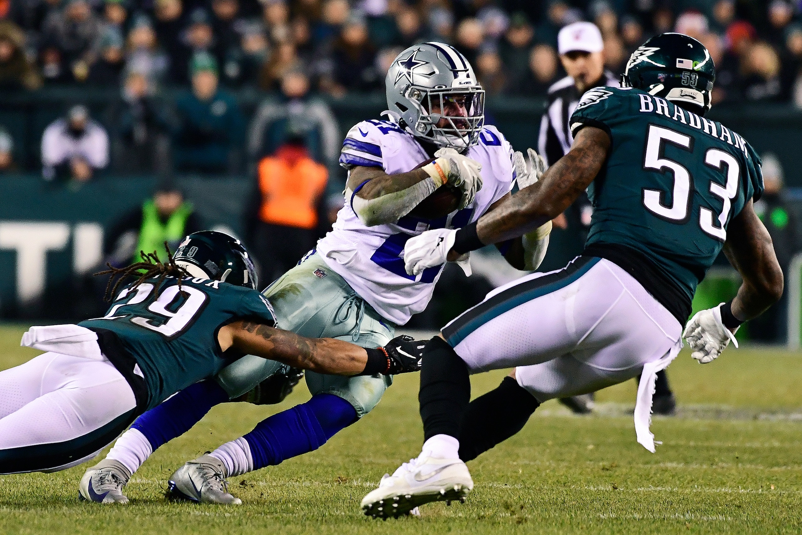 PHILADELPHIA, PA - DECEMBER 22: Ezekiel Elliott #21 of the Dallas Cowboys is tackled by Avonte Maddox #29 of the Philadelphia Eagles as teammate Nigel Bradham #53 pressures during the fourth quarter at Lincoln Financial Field on December 22, 2019 in Phila PHILADELPHIA, PA - DECEMBER 22: Ezekiel Elliott #21 of the Dallas Cowboys is tackled by Avonte Maddox #29 of the Philadelphia Eagles as teammate Nigel Bradham #53 pressures during the fourth quarter at Lincoln Financial Field on December 22, 2019 in Phila
