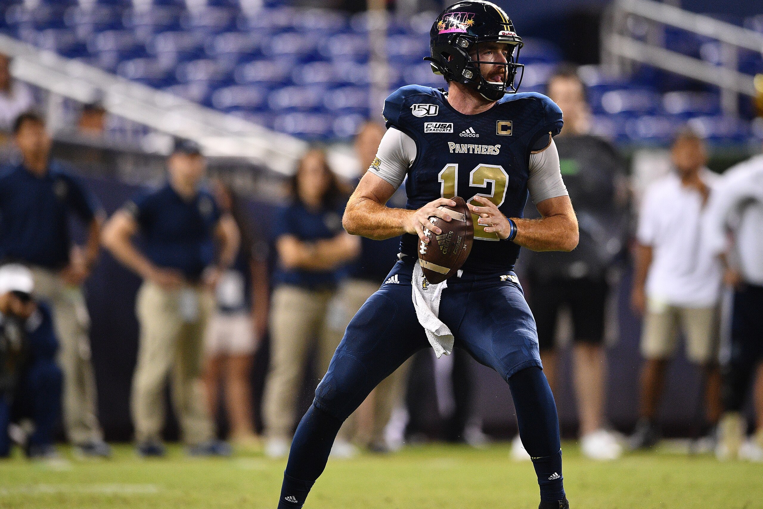 MIAMI, FLORIDA - NOVEMBER 23: James Morgan #12 of the FIU Golden Panthers looks to pass against the Miami Hurricanes in the second half at Marlins Park on November 23, 2019 in Miami, Florida. (Photo by Mark Brown/Getty Images)