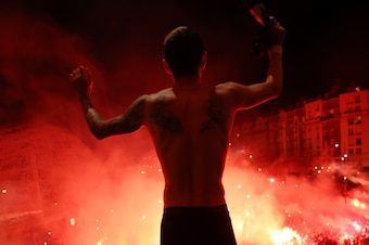 PARIS, FRANCE - MARCH 11: (FREE FOR EDITORIAL USE) In this handout image provided by UEFA, Angel Di Maria of Paris Saint-Germain celebrates victory with fans outside the stadium after the UEFA Champions League round of 16 second leg match between Paris Sa