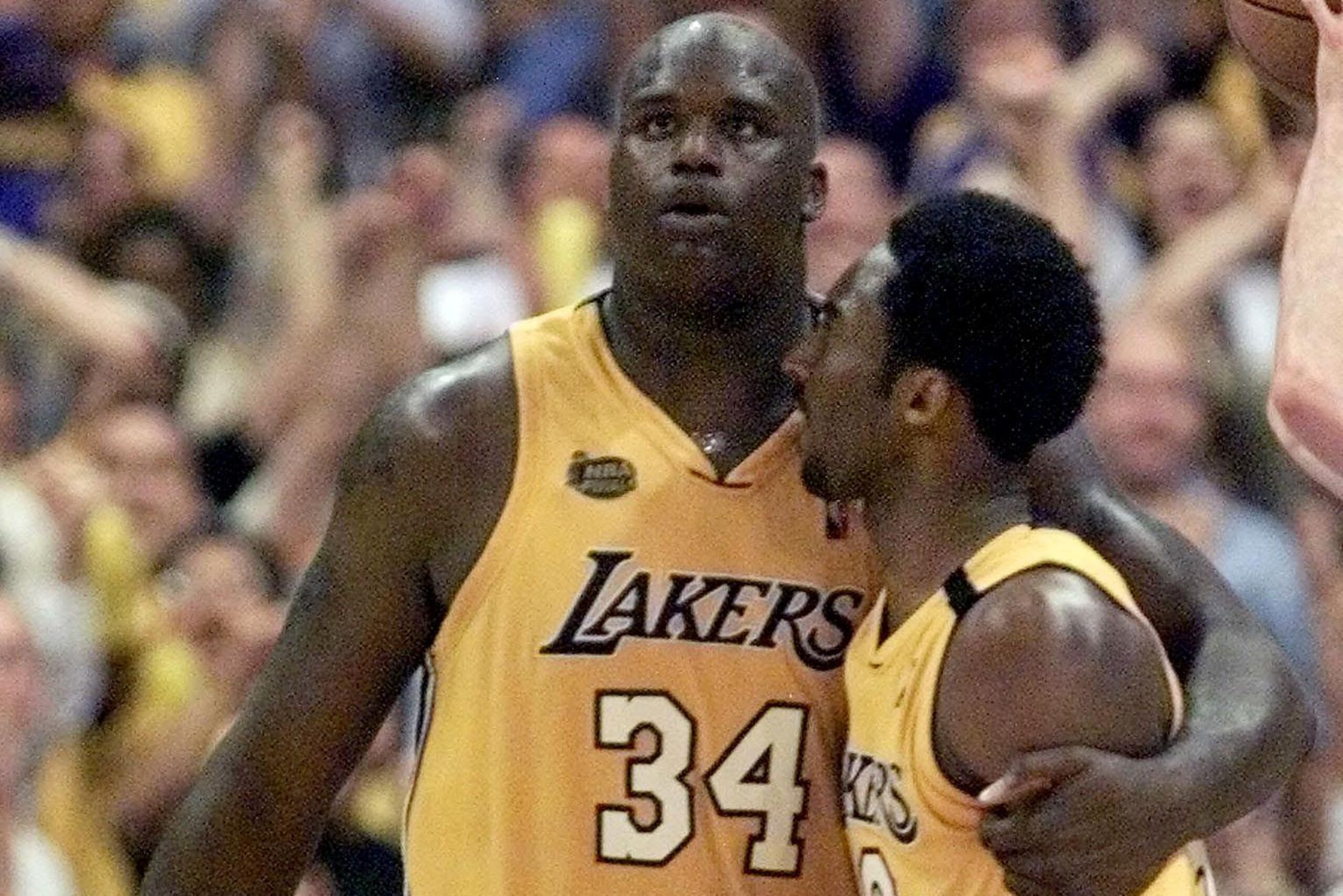 Shaquille O'Neal of the Los Angeles Lakers hugs teamate Kobe Bryant 19 June, 2000, during the second half of game 6 of the NBA Finals at Staples Center in Los Angeles, CA. The Pacers trail the Lakers 3-2 in the best-of-seven series. (ELECTRONIC IMAGE)  AF