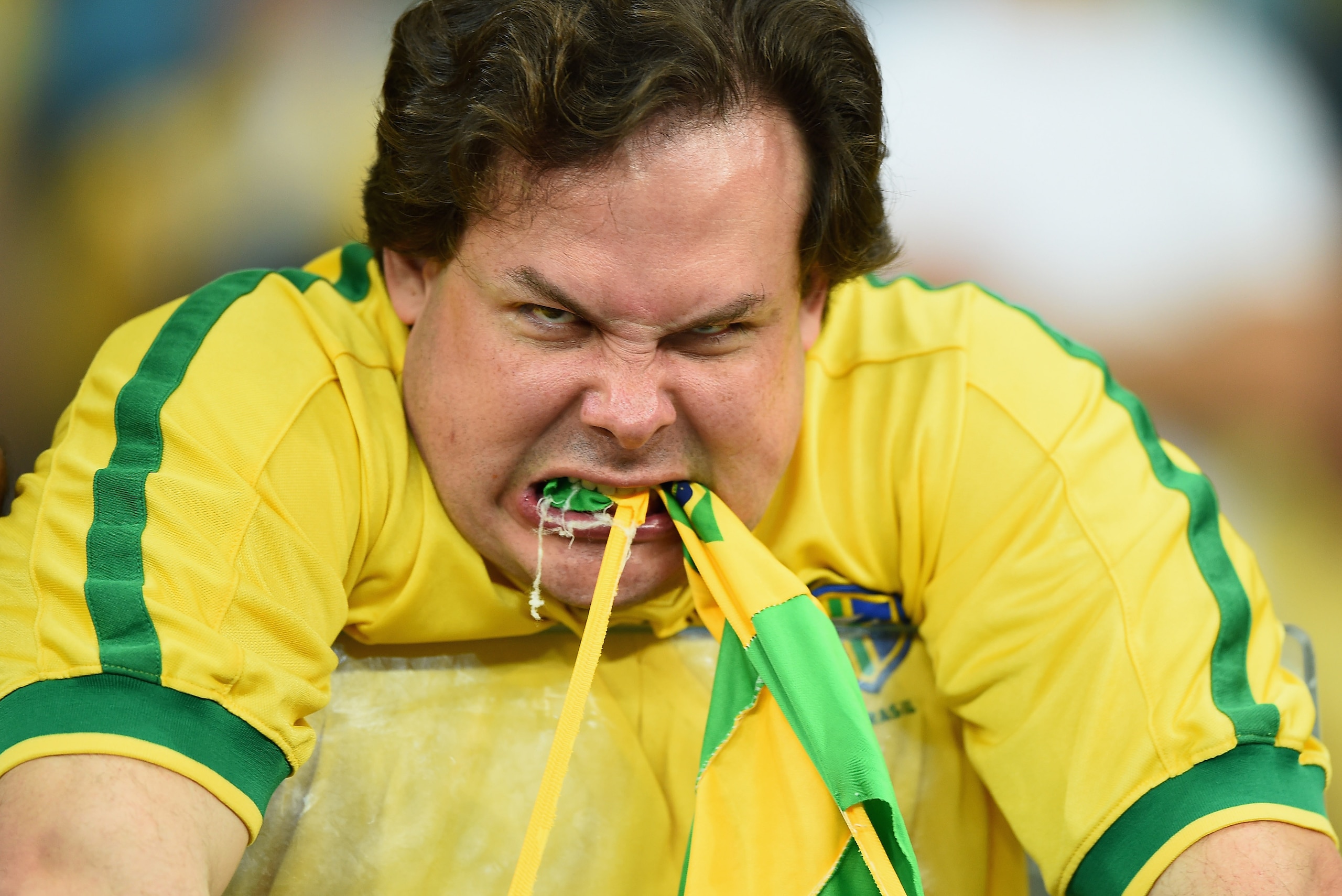 BELO HORIZONTE, BRAZIL - JULY 08: An emotional Brazil fan reacts after being defeated by Germany 7-1 after the 2014 FIFA World Cup Brazil Semi Final match between Brazil and Germanyat Estadio Mineirao on July 8, 2014 in Belo Horizonte, Brazil.  (Photo by 
