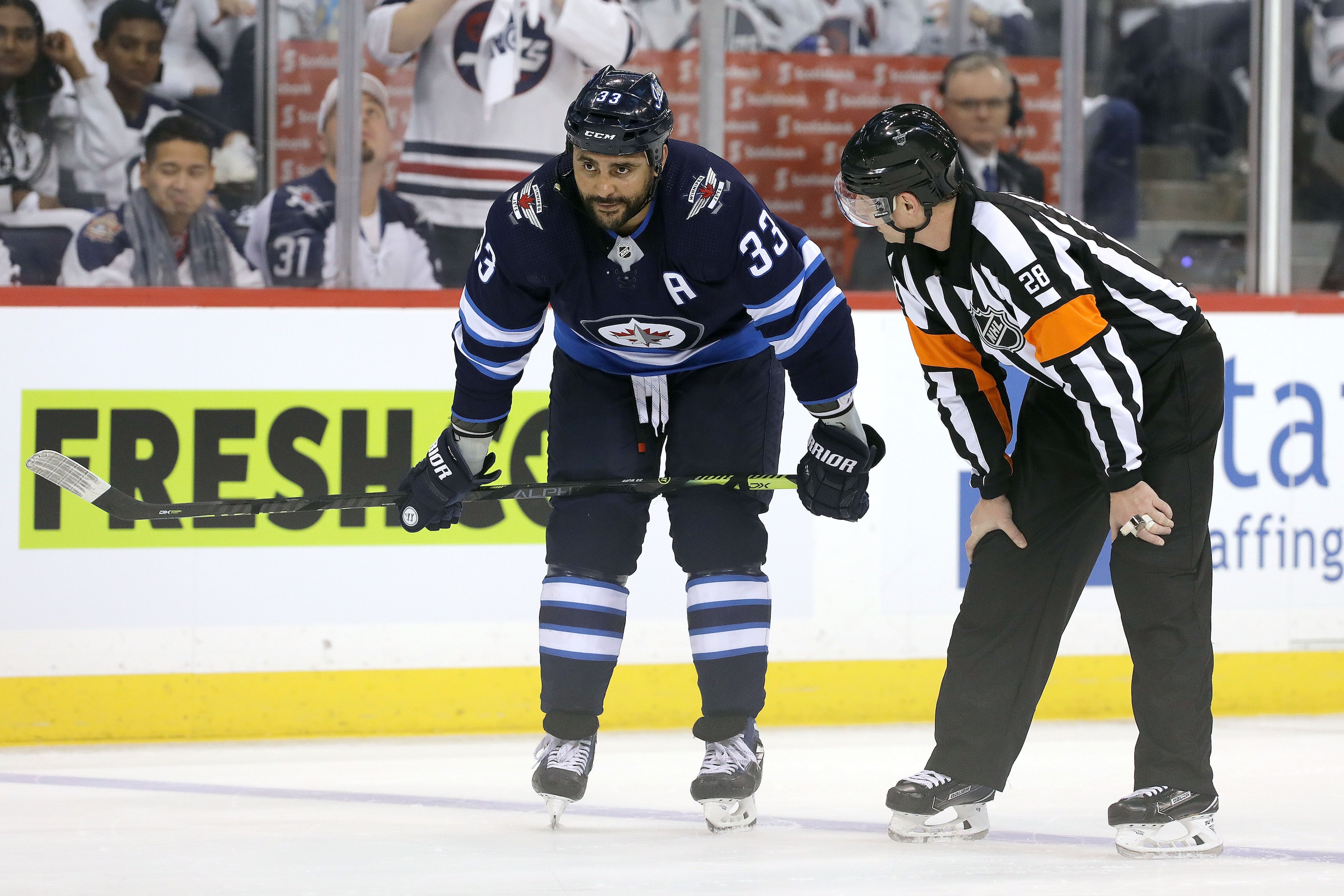 WINNIPEG, MANITOBA - APRIL 10: Dustin Byfuglien #33 of the Winnipeg Jets chats to a referee during a break in action with the St. Louis Blues in Game One of the Western Conference First Round during the 2019 NHL Stanley Cup Playoffs at Bell MTS Place on A