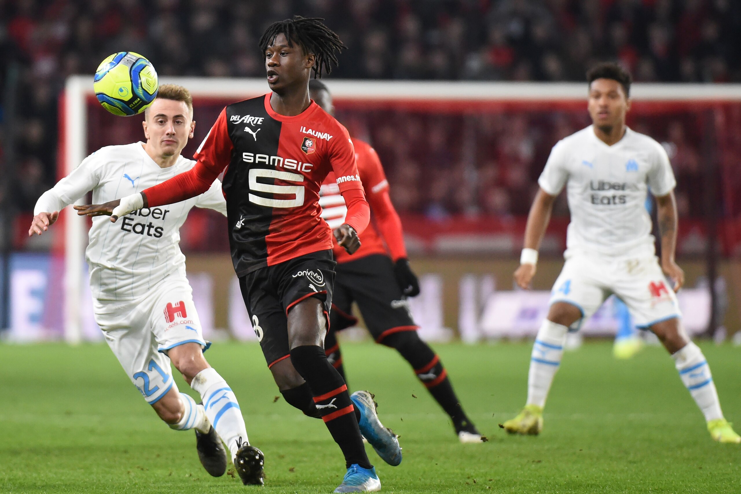 Rennes' French midfielder Eduardo Camavinga (C) fights for the ball against Marseille's French defender Valentin Rongier (L) during the French L1 Football match between Stade Rennais Football Club and Olympique de Marseille, on January 10, 2020, at the Ro