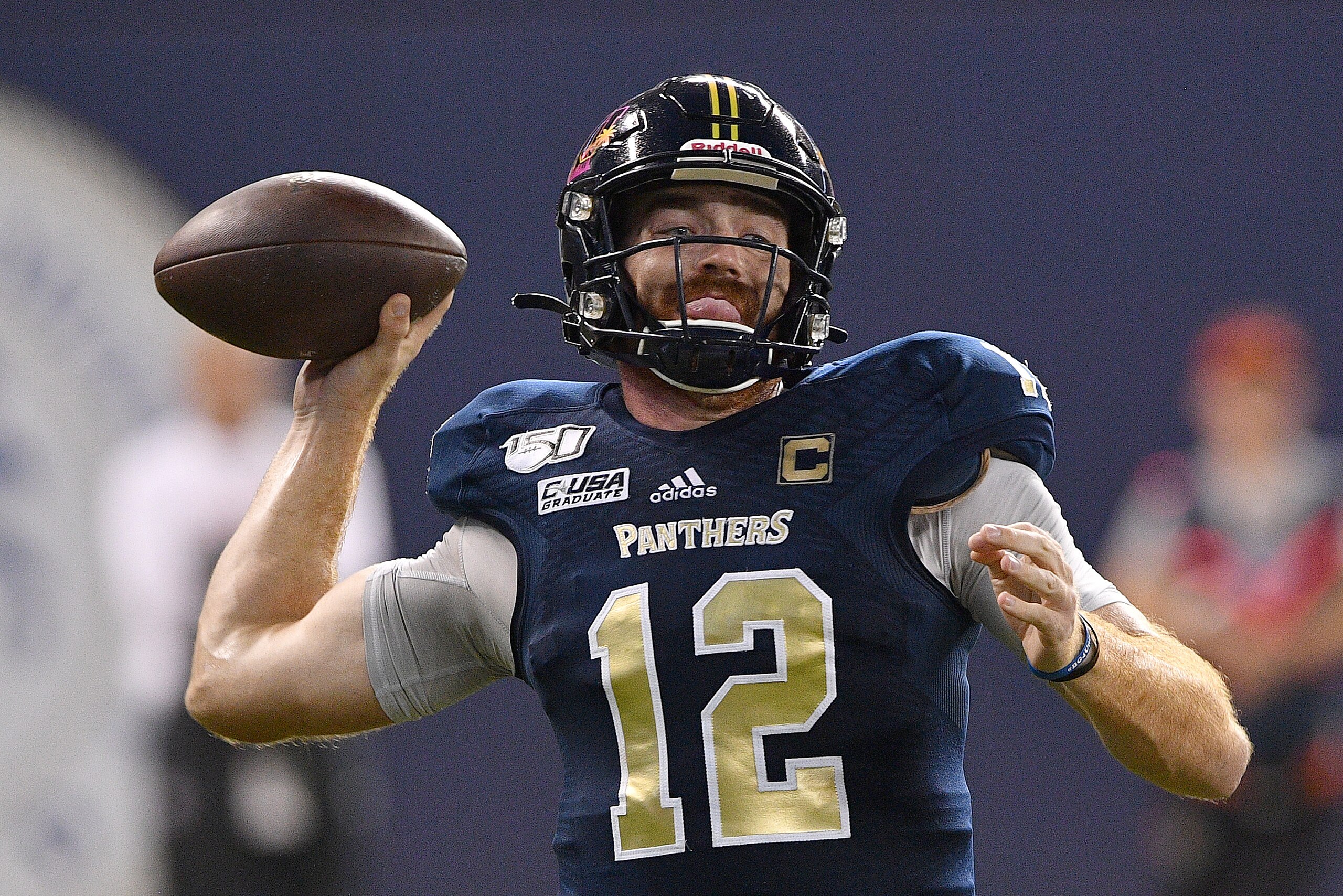 MIAMI, FLORIDA - NOVEMBER 23: James Morgan #12 of the FIU Golden Panthers looks to pass against the Miami Hurricanes in the second half at Marlins Park on November 23, 2019 in Miami, Florida. (Photo by Mark Brown/Getty Images)
