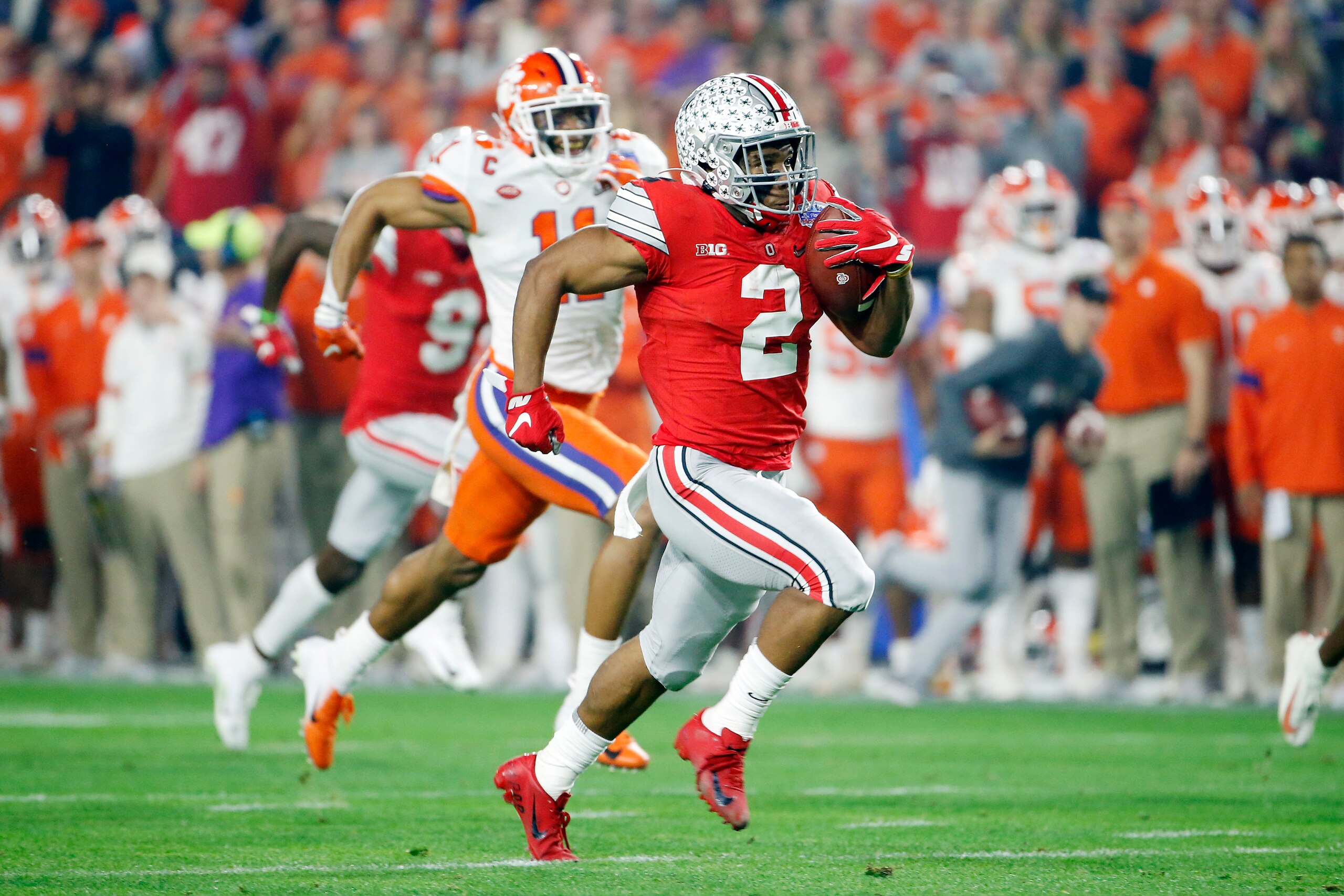 GLENDALE, ARIZONA - DECEMBER 28:  J.K. Dobbins #2 of the Ohio State Buckeyes runs the ball for 68-yard a touchdown against the Clemson Tigers in the first half during the College Football Playoff Semifinal at the PlayStation Fiesta Bowl at State Farm Stad