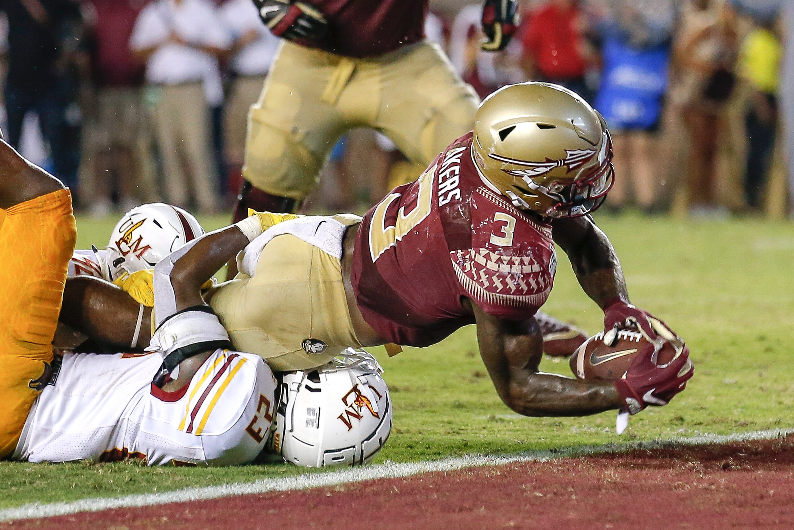 TALLAHASSEE, FL - SEPTEMBER 7: Runningback Cam Akers #3 of the Florida State Seminoles goes over Defensive Back Nick Ingram #23 of the Louisiana Monroe Warhawks in overtime for the winning score during the game at Doak Campbell Stadium on Bobby Bowden Fie