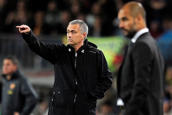 Real Madrid's Portuguese coach Jose Mourinho (L) and Barcelona's coach Josep Guardiola gesture during the Spanish League