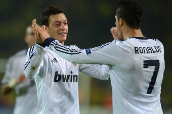 Real Madrid's Portuguese forward Cristiano Ronaldo (R) celebrates scoring the 1-1 equalizer with German teammate midfielder Mesut Ozil during the UEFA Champions League Group D football match BVB Borussia Dortmund vs Real Madrid in Dortmund, western German