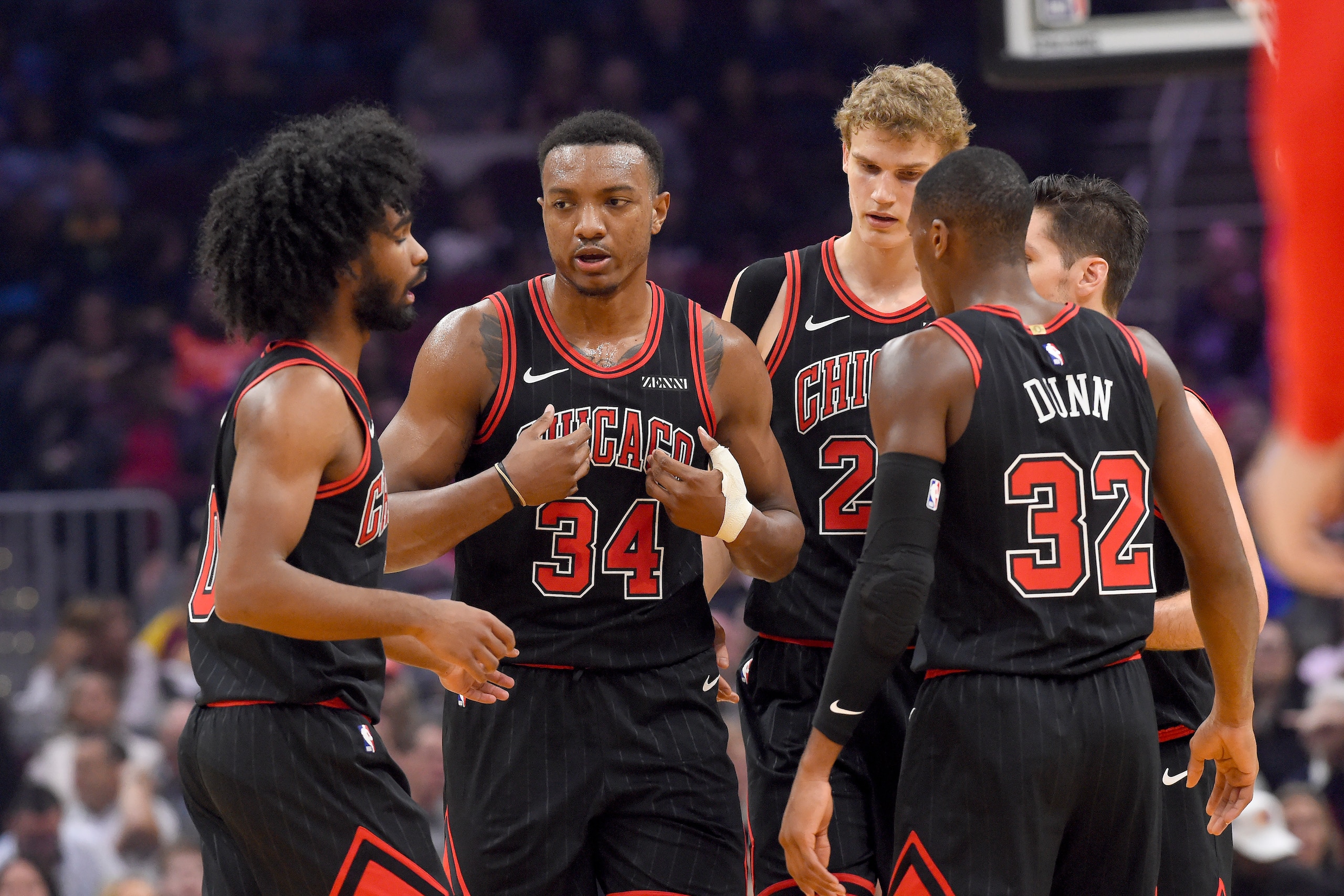 CLEVELAND, OHIO - OCTOBER 30: Coby White #0 Wendell Carter Jr. #34 Lauri Markkanen #24 and Kris Dunn #32 of the Chicago Bulls talk during a timeout during the first half against the Cleveland Cavaliers at Rocket Mortgage Fieldhouse on October 30, 2019 in 