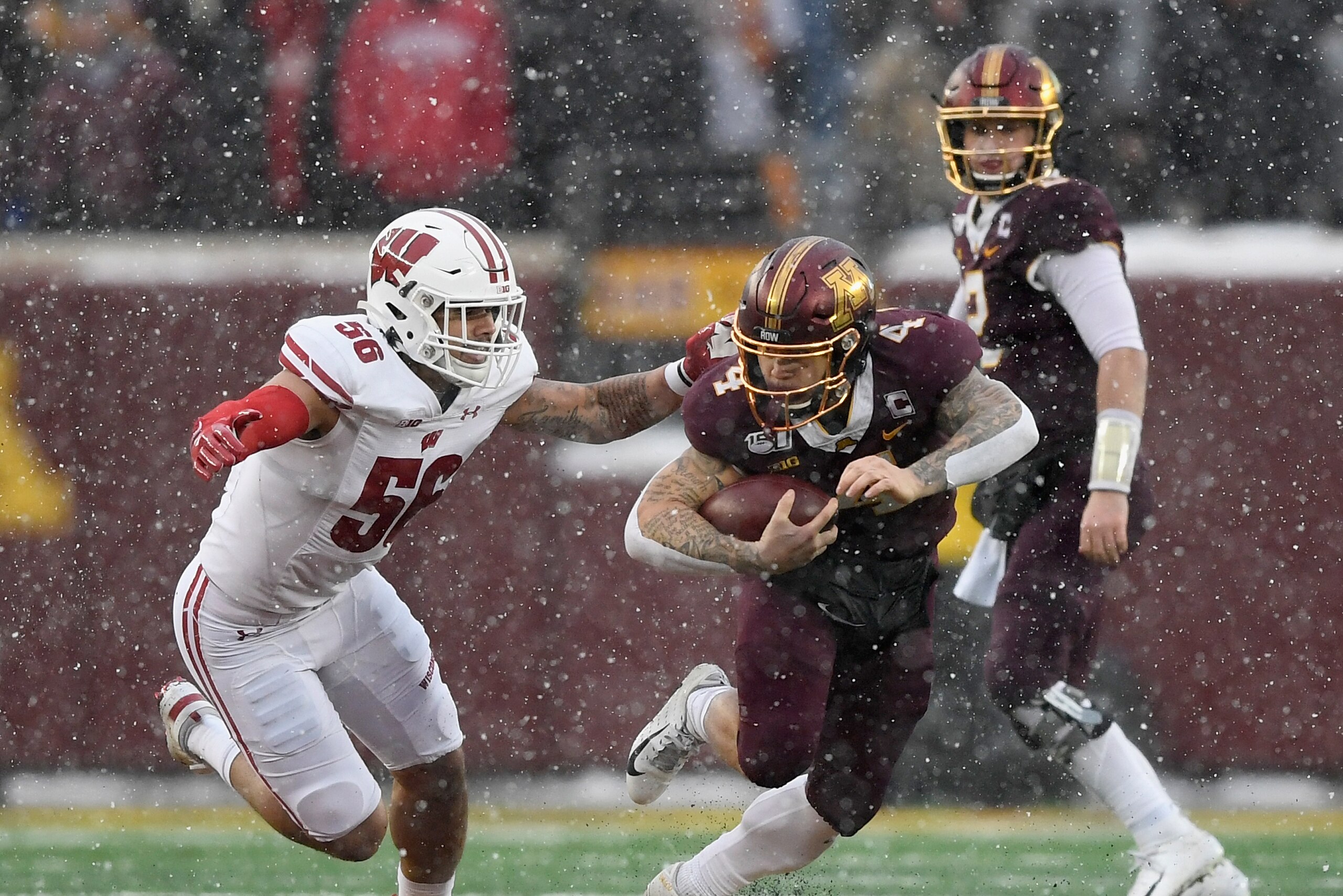 MINNEAPOLIS, MINNESOTA - NOVEMBER 30: Zack Baun #56 of the Wisconsin Badgers tackles Shannon Brooks #4 of the Minnesota Golden Gophers during the second quarter of the game at TCF Bank Stadium on November 30, 2019 in Minneapolis, Minnesota. (Photo by Hann
