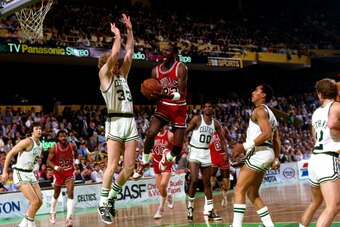 BOSTON, MA - 1986: Michael Jordan #23 of the Chicago Bulls drives to the basket against Larry Bird #33 of the Boston Celtics during a game circa 1986 at the Boston Garden in Boston, Massachusetts. NOTE TO USER: User expressly acknowledges and agrees that,