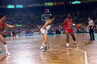 BOSTON - APRIL 17:  Michael Jordan #23 of the Chicago Bulls moves the ball up court against Dennis Johnson #3 of the Boston Celtics in Game One of the Eastern Conference Quarterfinals during the 1986 NBA Playoffs played on April 17, 1986 at the Boston Gar