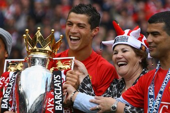 MANCHESTER, ENGLAND - MAY 16:  Cristiano Ronaldo of Manchester United celebrates winning the Barclays Premier League trophy with his mother, Dolores Aveiro after the Barclays Premier League match between Manchester United and Arsenal at Old Trafford on Ma