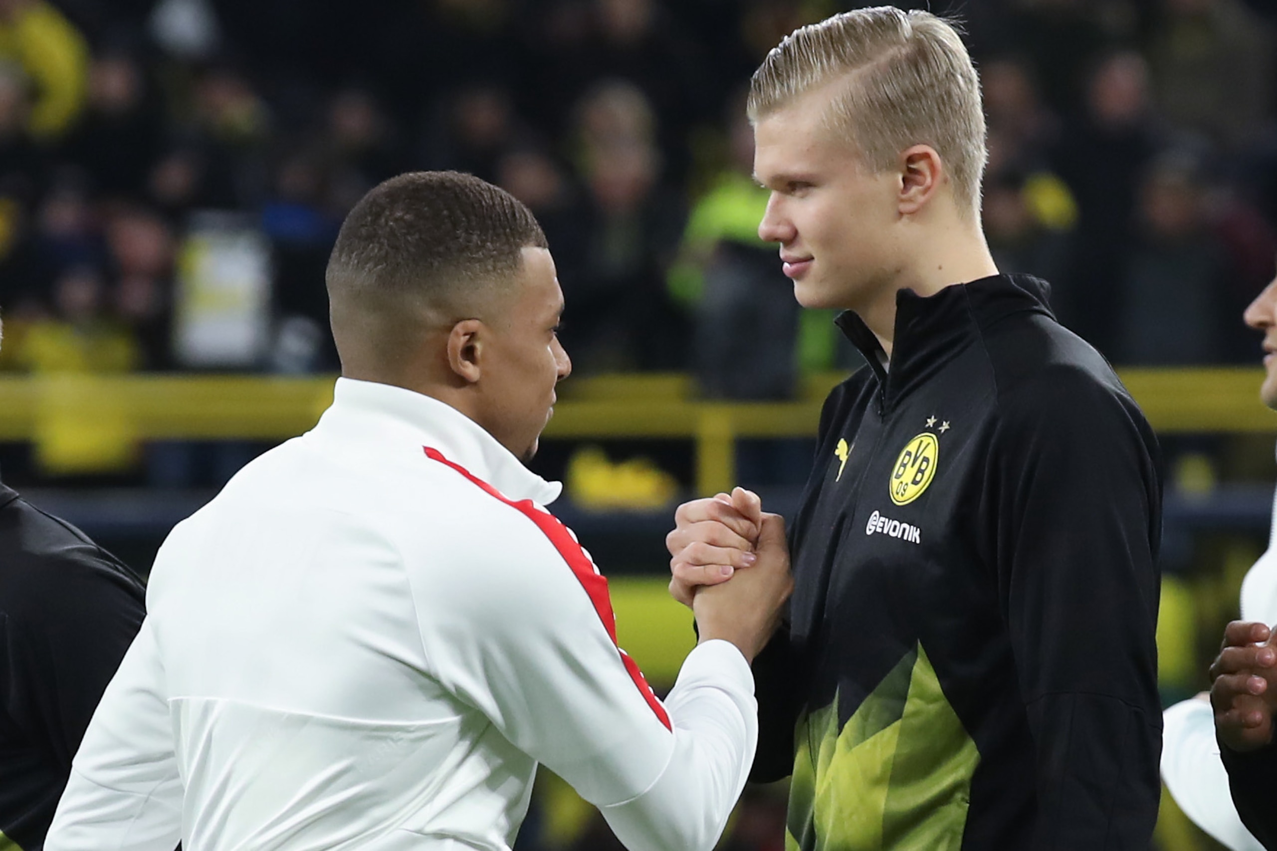 DORTMUND, GERMANY - FEBRUARY 18: Kilian Mbappe of Paris Saint-Germain shakes hands with Erling Haaland of Dortmund prior to the UEFA Champions League round of 16 first leg match between Borussia Dortmund and Paris Saint-Germain at Signal Iduna Park on Feb