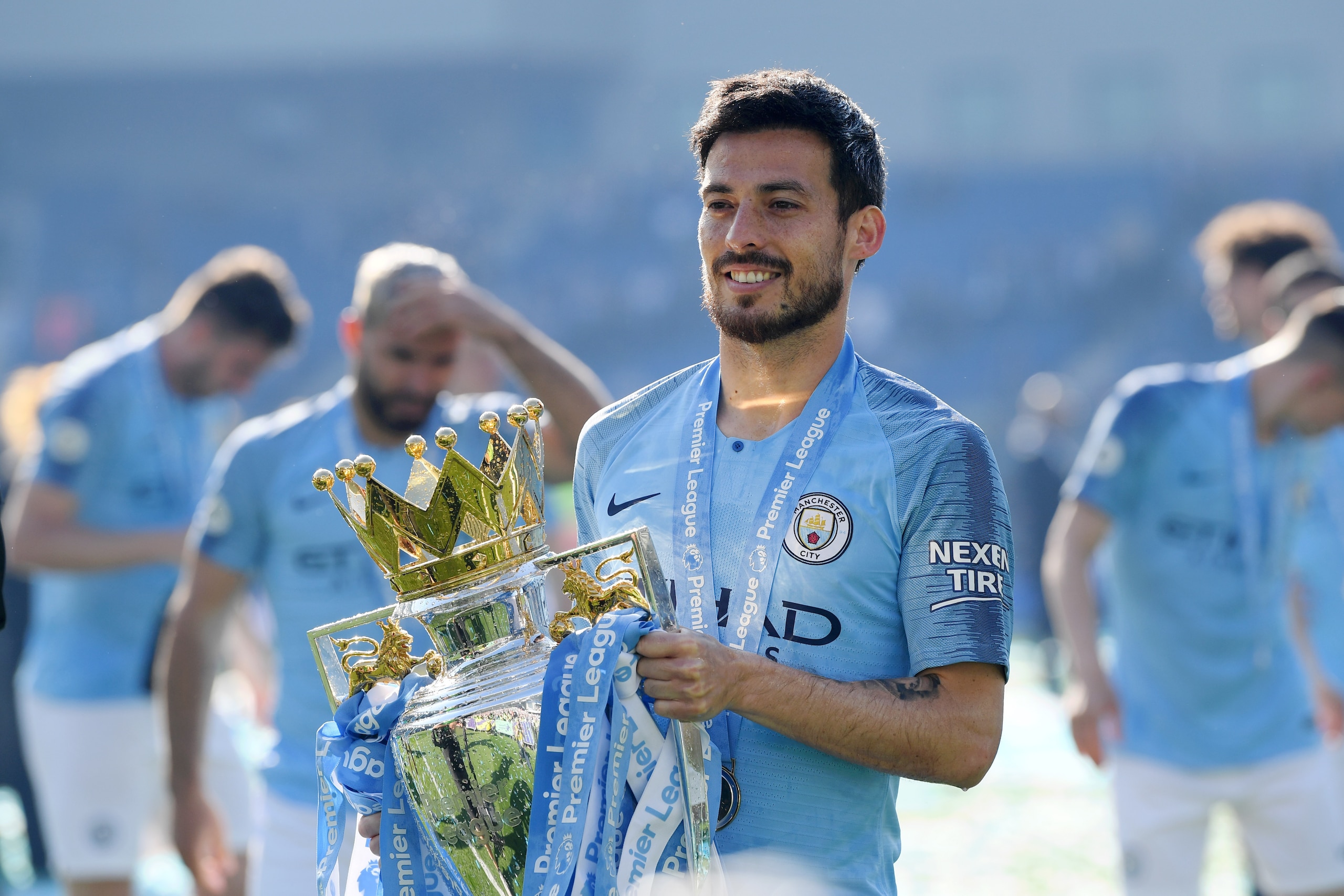 BRIGHTON, ENGLAND - MAY 12: David Silva of Manchester City celebrates with the Premier League Trophy after winning the title following the Premier League match between Brighton & Hove Albion and Manchester City at American Express Community Stadium on May BRIGHTON, ENGLAND - MAY 12: David Silva of Manchester City celebrates with the Premier League Trophy after winning the title following the Premier League match between Brighton & Hove Albion and Manchester City at American Express Community Stadium on May