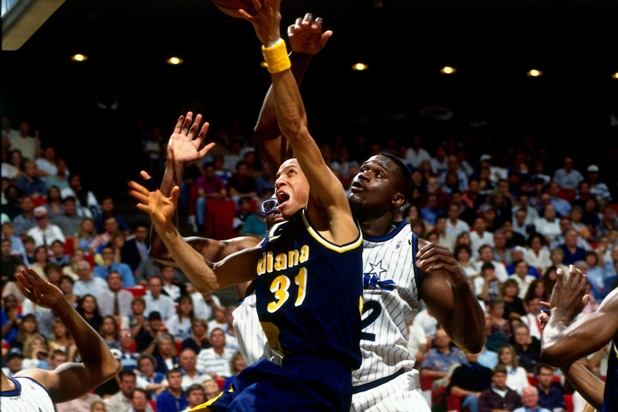 ORLANDO, FL - MAY 23: Reggie Miller #31 of the Indiana Pacers shoots the ball against Shaquille O'Neal #32 of the Orlando Magic during game 1 of the Eastern Conference Finals on May 23, 1995 at the Orlando Arena in Orlando, Florida. NOTE TO USER: User ex ORLANDO, FL - MAY 23: Reggie Miller #31 of the Indiana Pacers shoots the ball against Shaquille O'Neal #32 of the Orlando Magic during game 1 of the Eastern Conference Finals on May 23, 1995 at the Orlando Arena in Orlando, Florida. NOTE TO USER: User ex