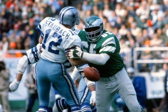 PHILADELPHIA, PA - OCTOBER 23: Charlie Johnson #65 of the Philadelphia Eagles knocks the ball out of the hand of quarterback Roger Staubach #12 of the Dallas Cowboys during an NFL football game October 23, 1977 at Veterans Stadium in Philadelphia, Pennsyl