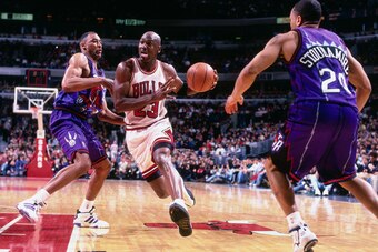 CHICAGO, IL - JANUARY 25: Michael Jordan #23 of the Chicago Bulls handles the ball during the game against the Toronto Raptors on January 25, 1997 at the United Center in Chicago, IL. NOTE TO USER: User expressly acknowledges and agrees that, by downloadi