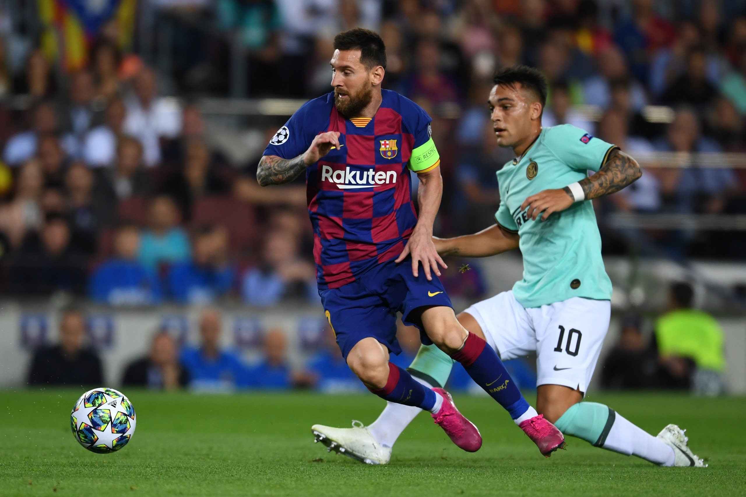 BARCELONA, SPAIN - OCTOBER 02: Lionel Messi of FC Barcelona and Lautaro Martinez of Inter compete for the ball during the UEFA Champions League group F match between FC Barcelona and Inter at Camp Nou on October 02, 2019 in Barcelona, Spain. (Photo by Ets